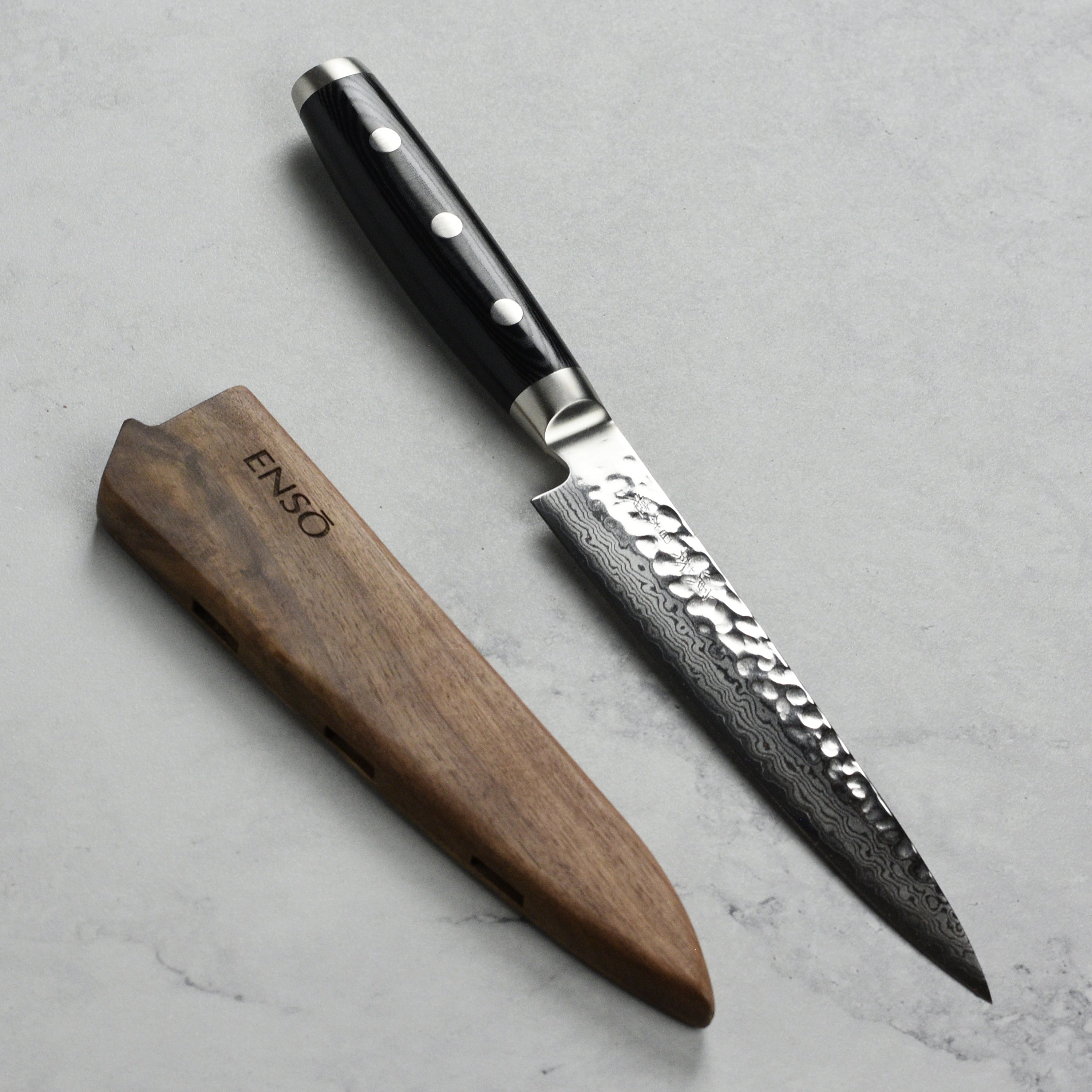 Close-up of the Enso Walnut Knife Holder demonstrating its secure fit for a 6-inch utility knife.