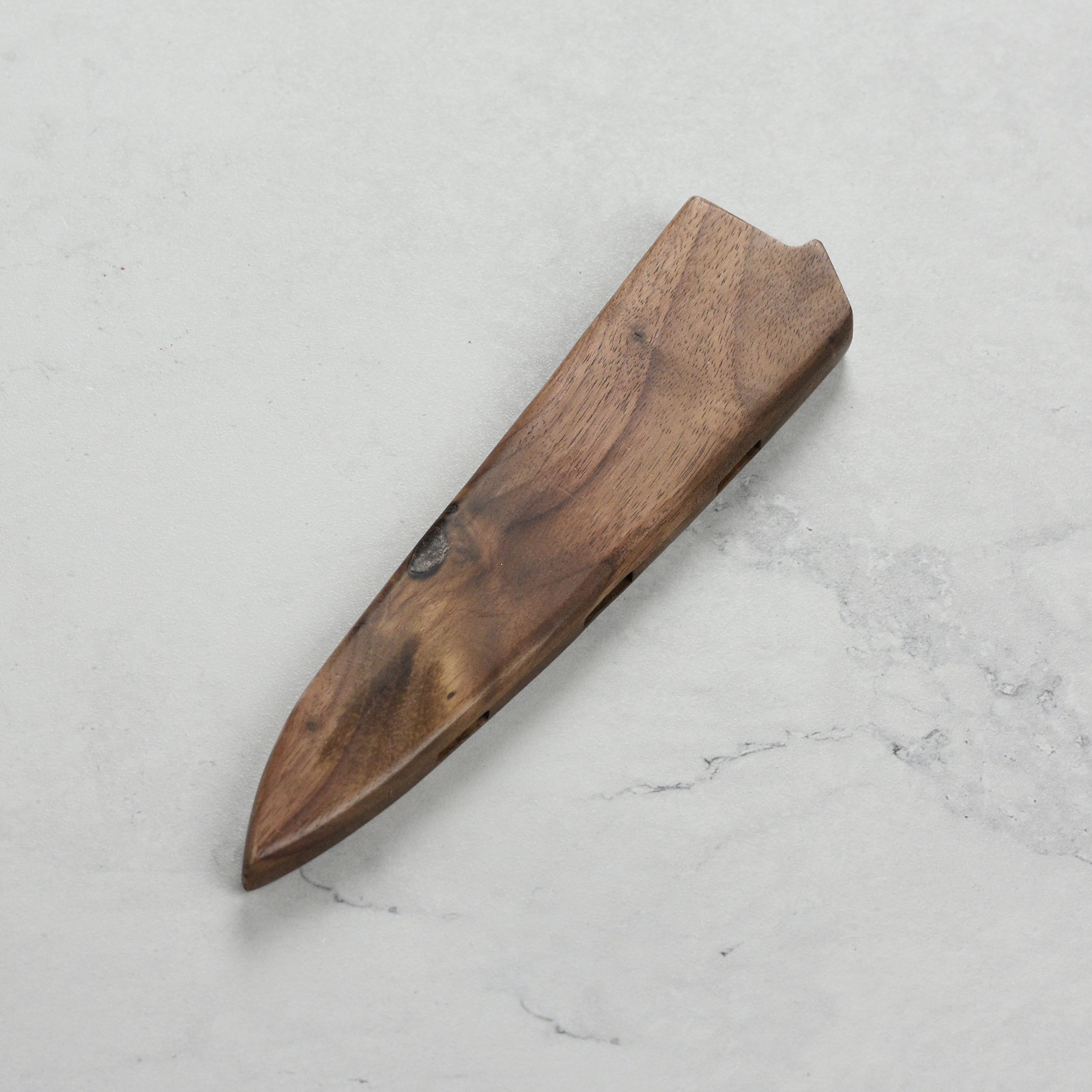 Vent holes in the Enso Walnut Knife Sheath facilitating airflow for optimal knife maintenance.