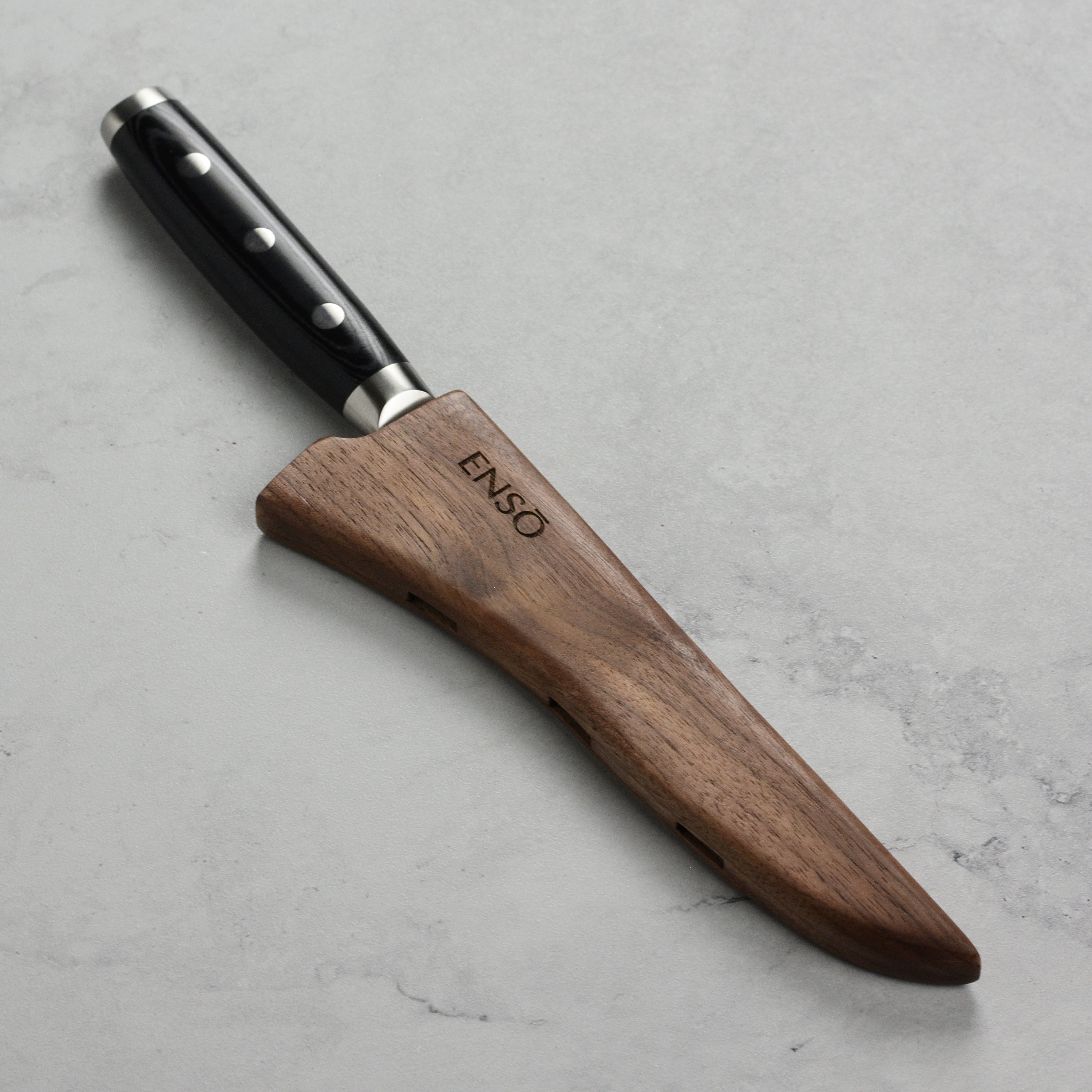 Side view of magnetic knife sheath showing vent holes and magnetic edge