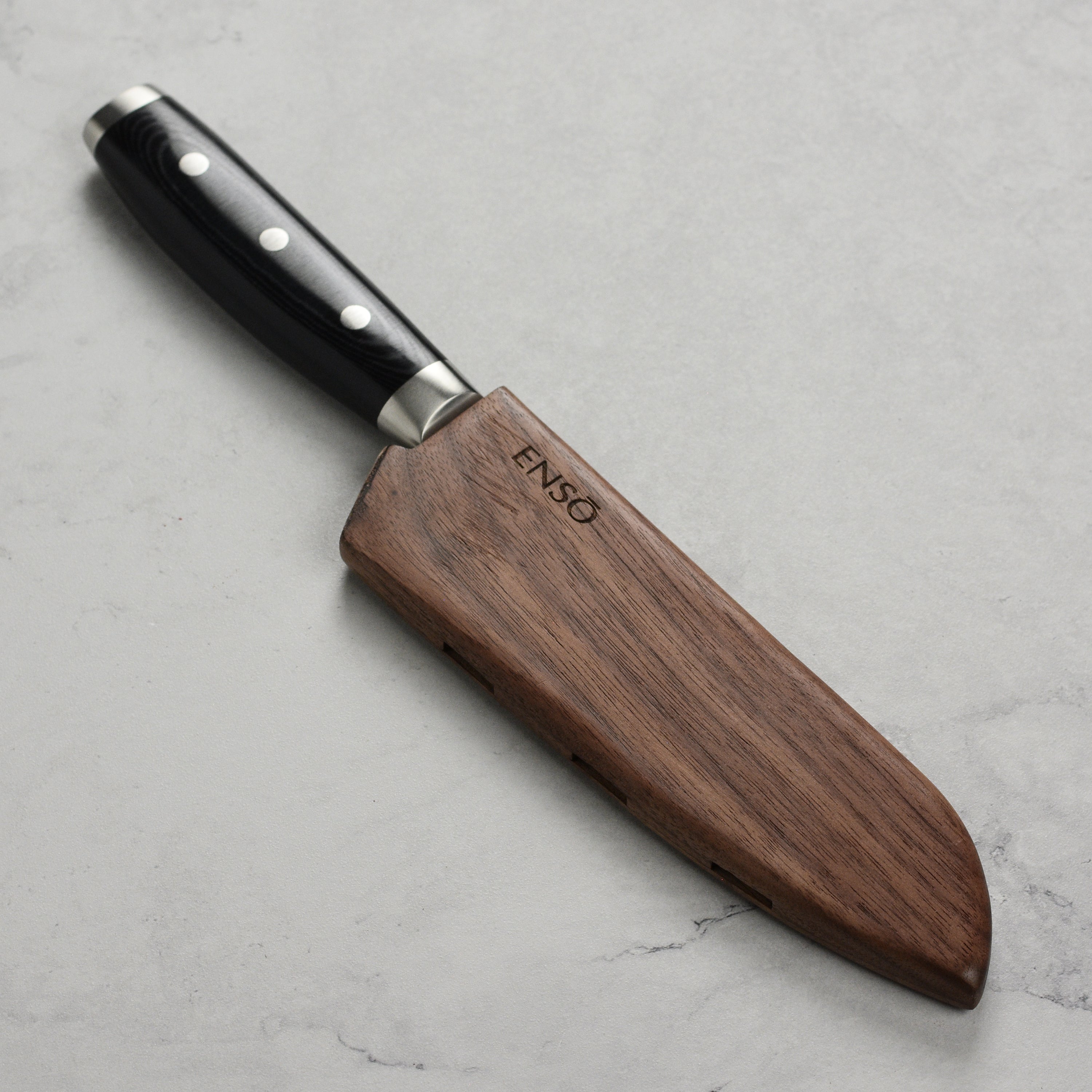 Side angle view showing magnetic closure detail on walnut knife protector