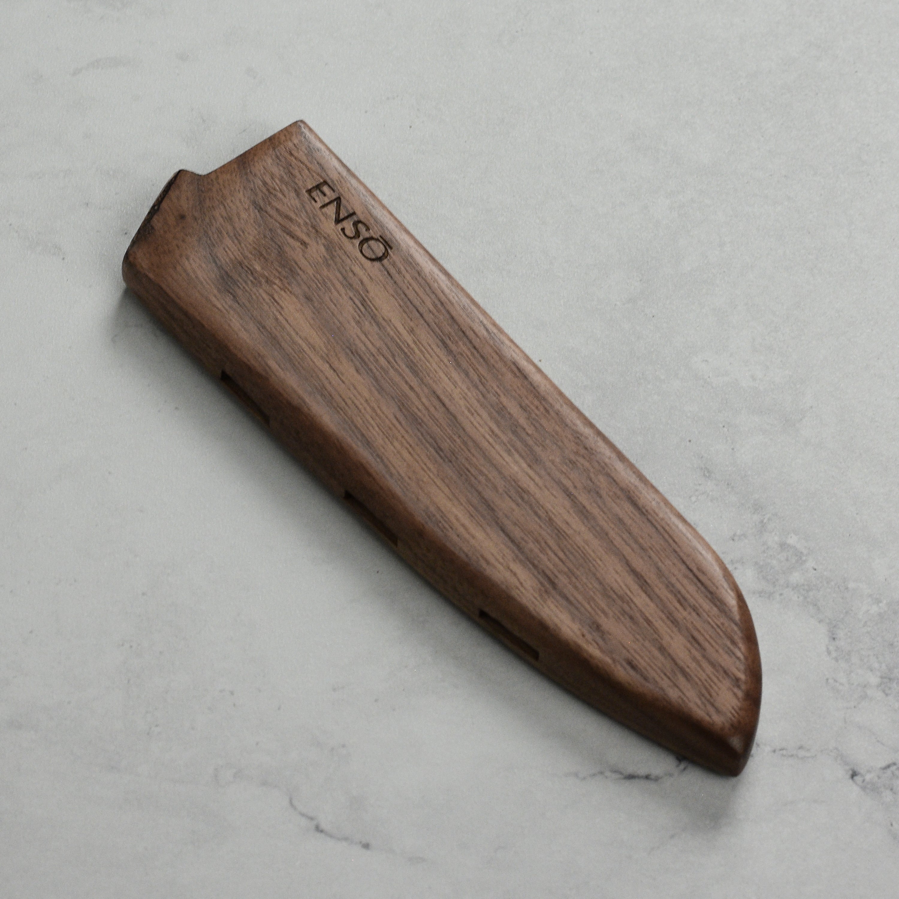 Close-up of walnut knife sheath securely attached to 6.5 inch Santoku blade