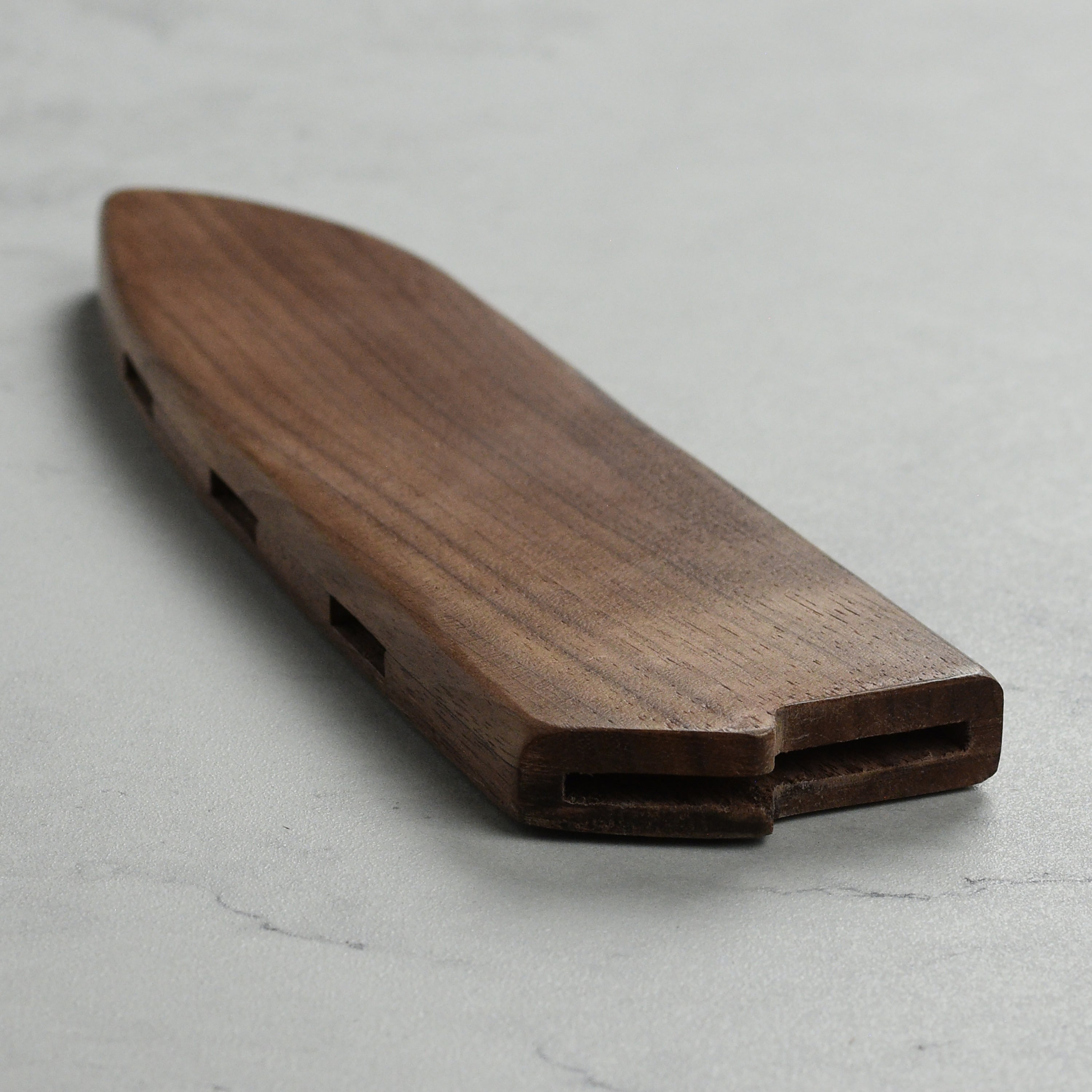 Knife sheath placed on countertop beside Santoku knife for daily use