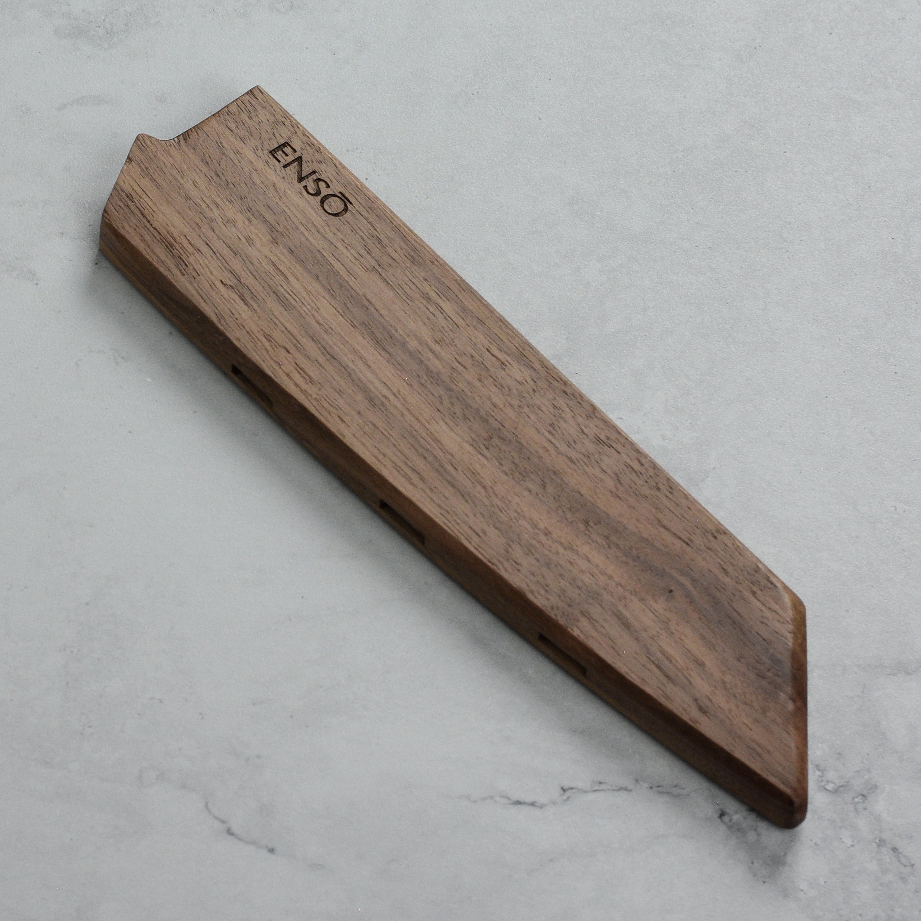 Close-up of the walnut magnetic knife sheath showing its sleek design and airflow vents.