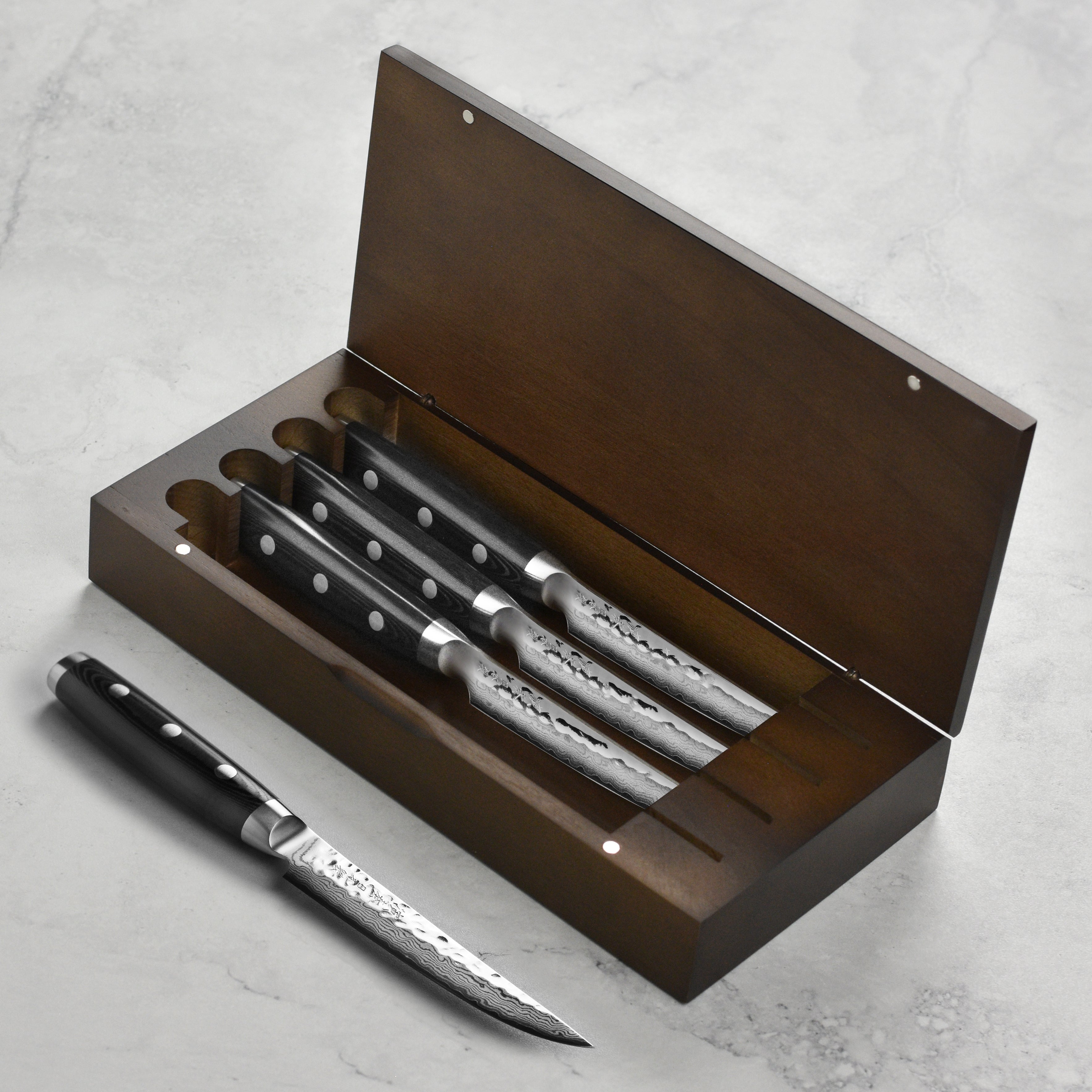 Close-up of the Seki Master Damascus steak knife highlighting the sharp blade and hammered finish.