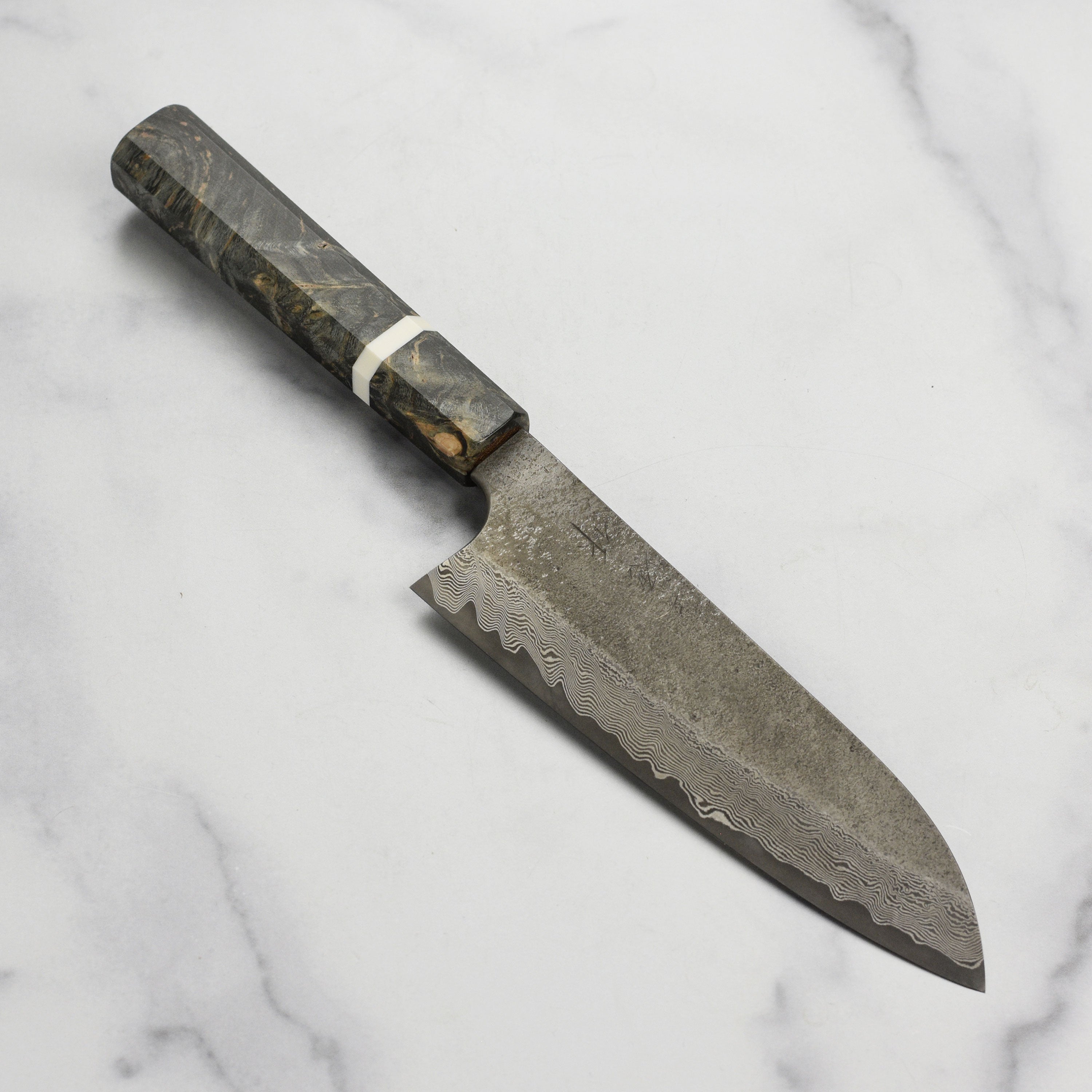 Close-up of Nigara Ginsan Kurozome Damascus Santoku knife showing damascus pattern