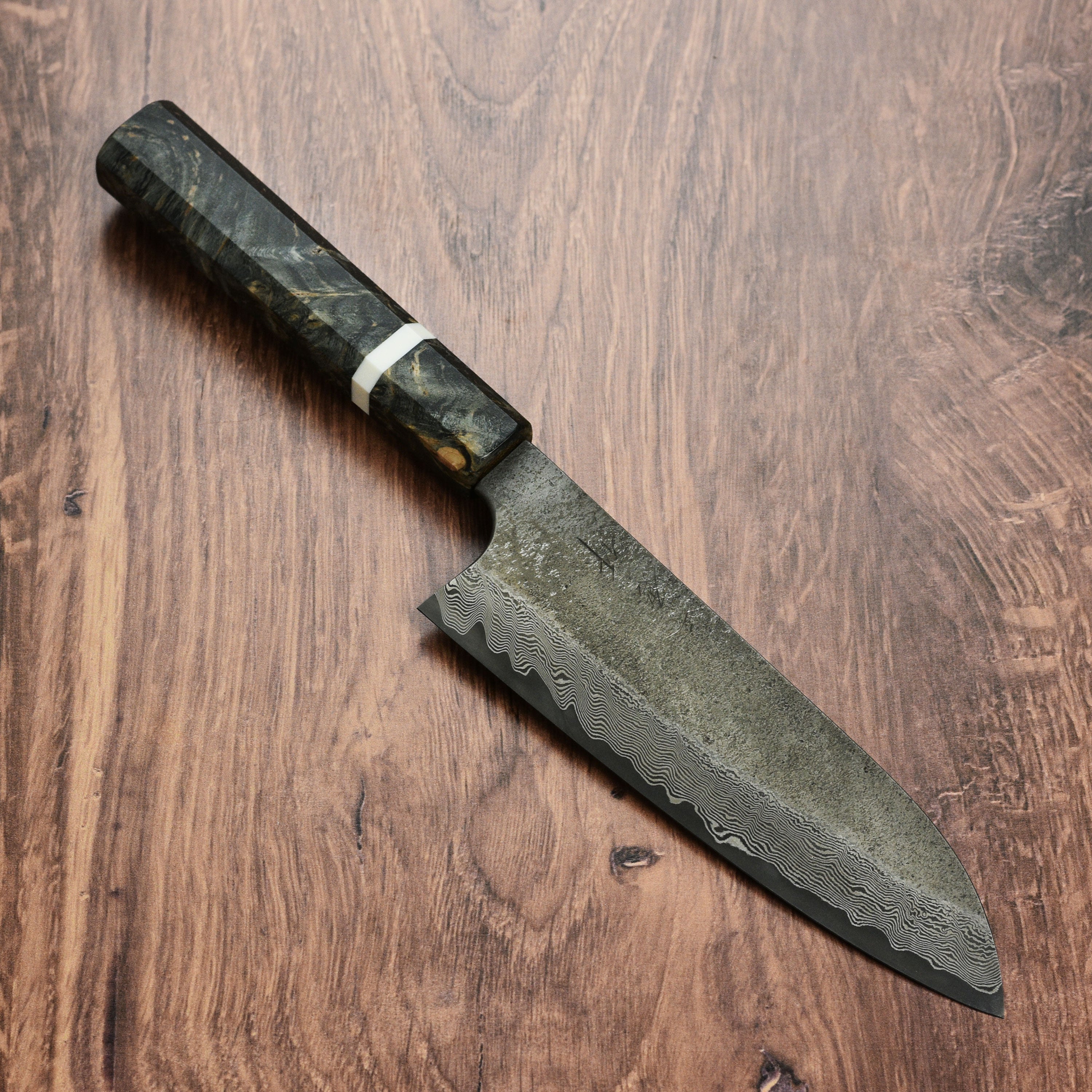 Chef using Nigara Ginsan Damascus Santoku for slicing vegetables