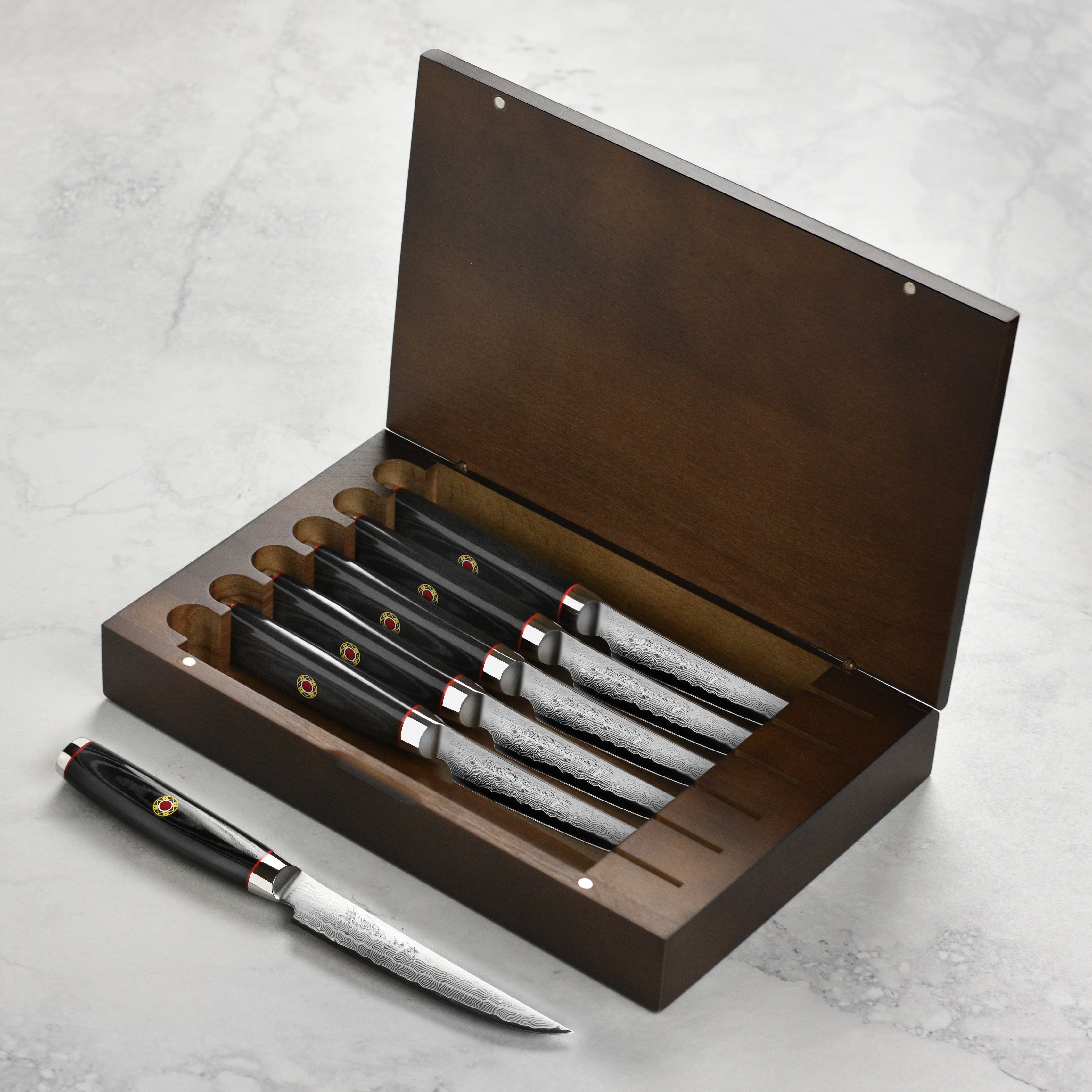 Side angle of Japanese Damascus steak knife highlighting 101-layer detail