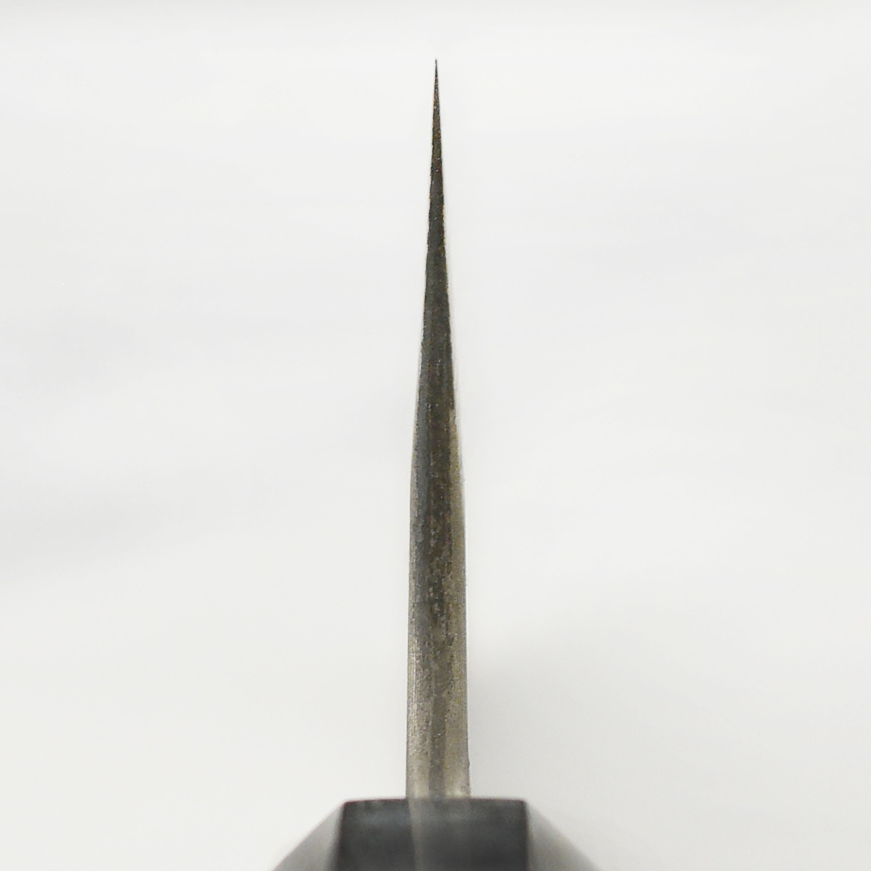 Chef holding Nigara Ginsan Kurozome Damascus knife for detailed chopping