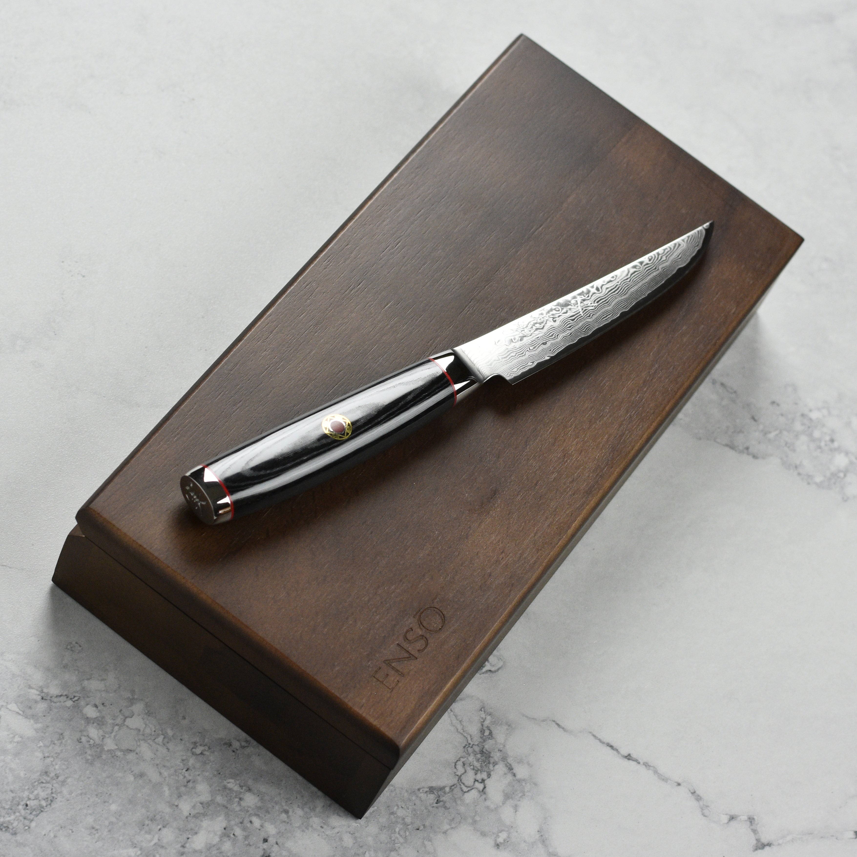 Japanese Damascus knives with detailed craftsmanship and ergonomic handles