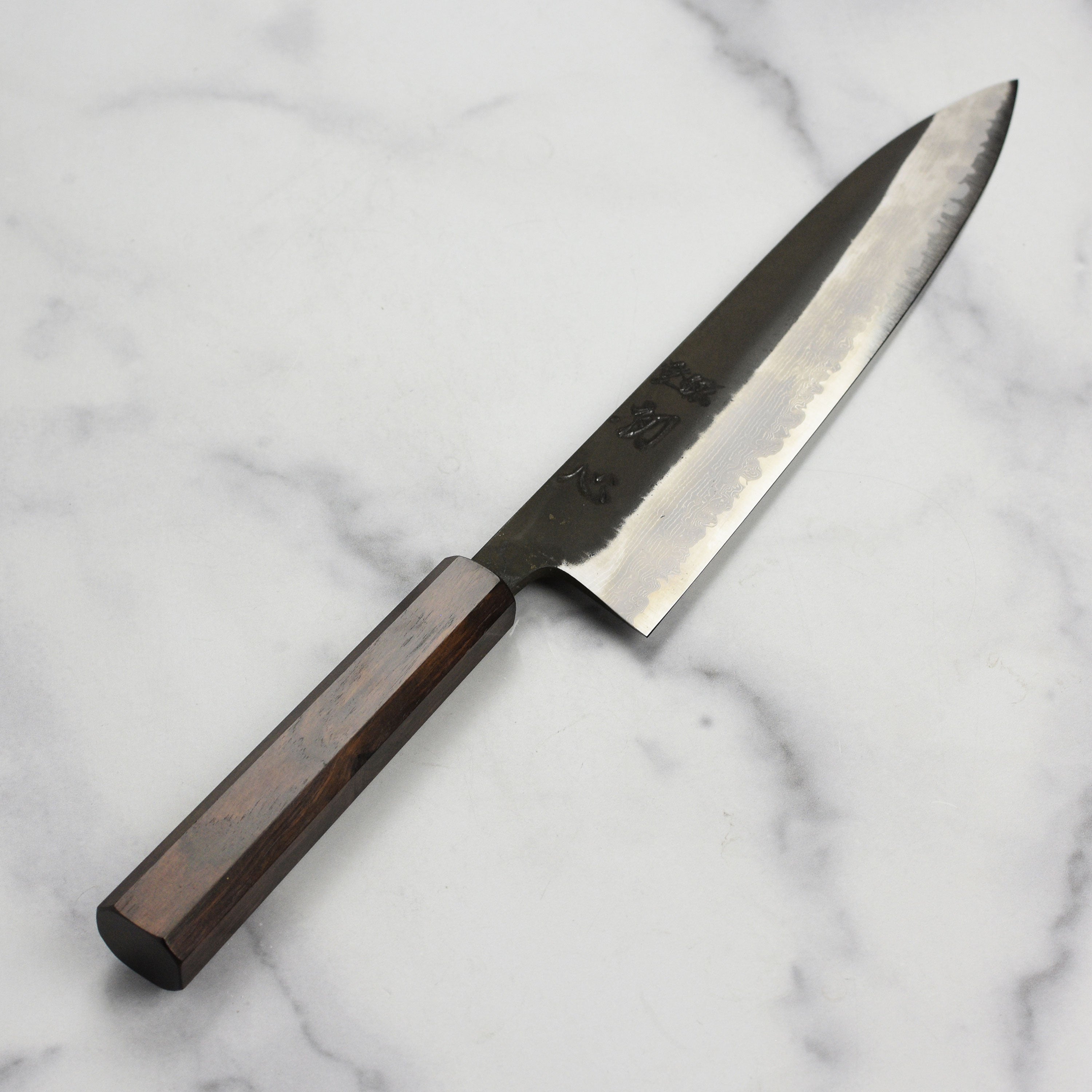 Japanese chef knife in action slicing vegetables on a cutting board