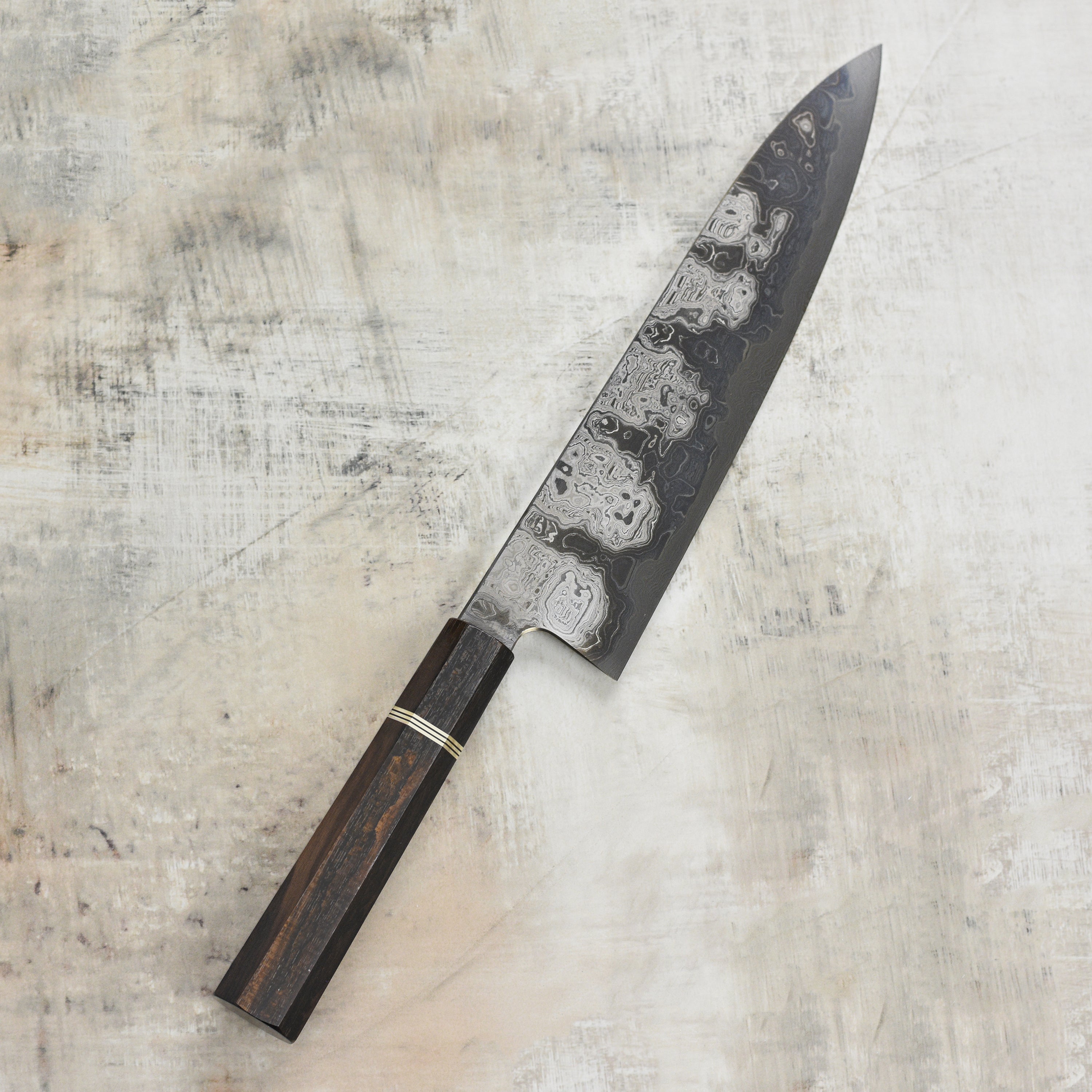 Close-up of the Shiomachi Aogami Gyuto knife cutting fresh vegetables, highlighting its sharp edge and craftsmanship.