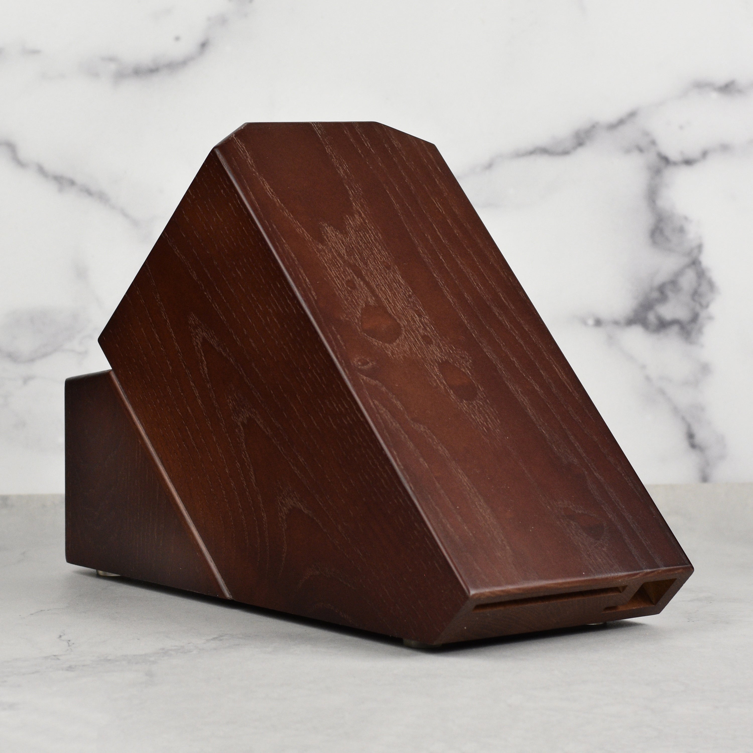 Close-up of the walnut knife block highlighting the horizontal slot design for blade protection.