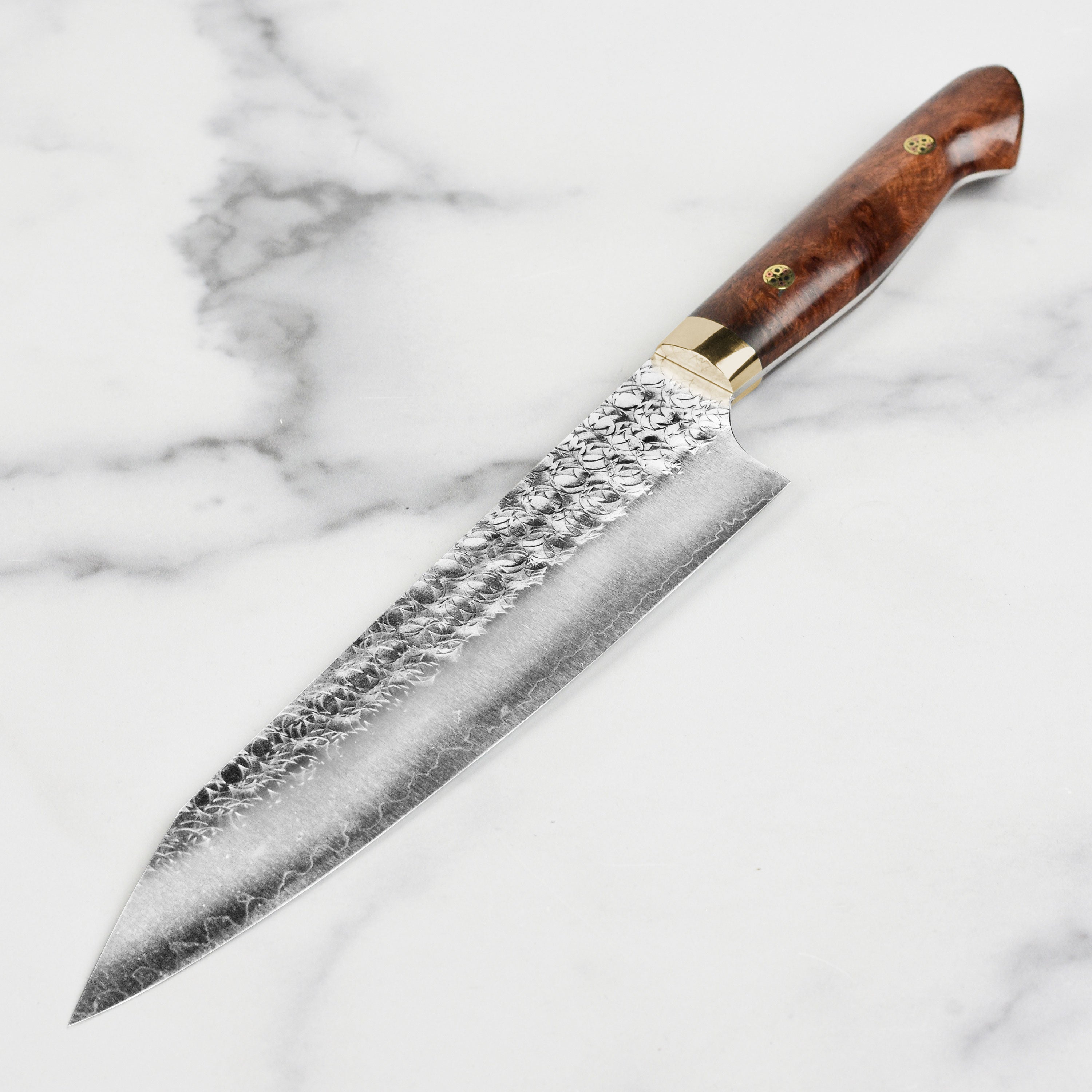 Yoshimi Kato Minamo SG2 Kiritsuke Gyuto Knife in action, expertly slicing vegetables on a cutting board.
