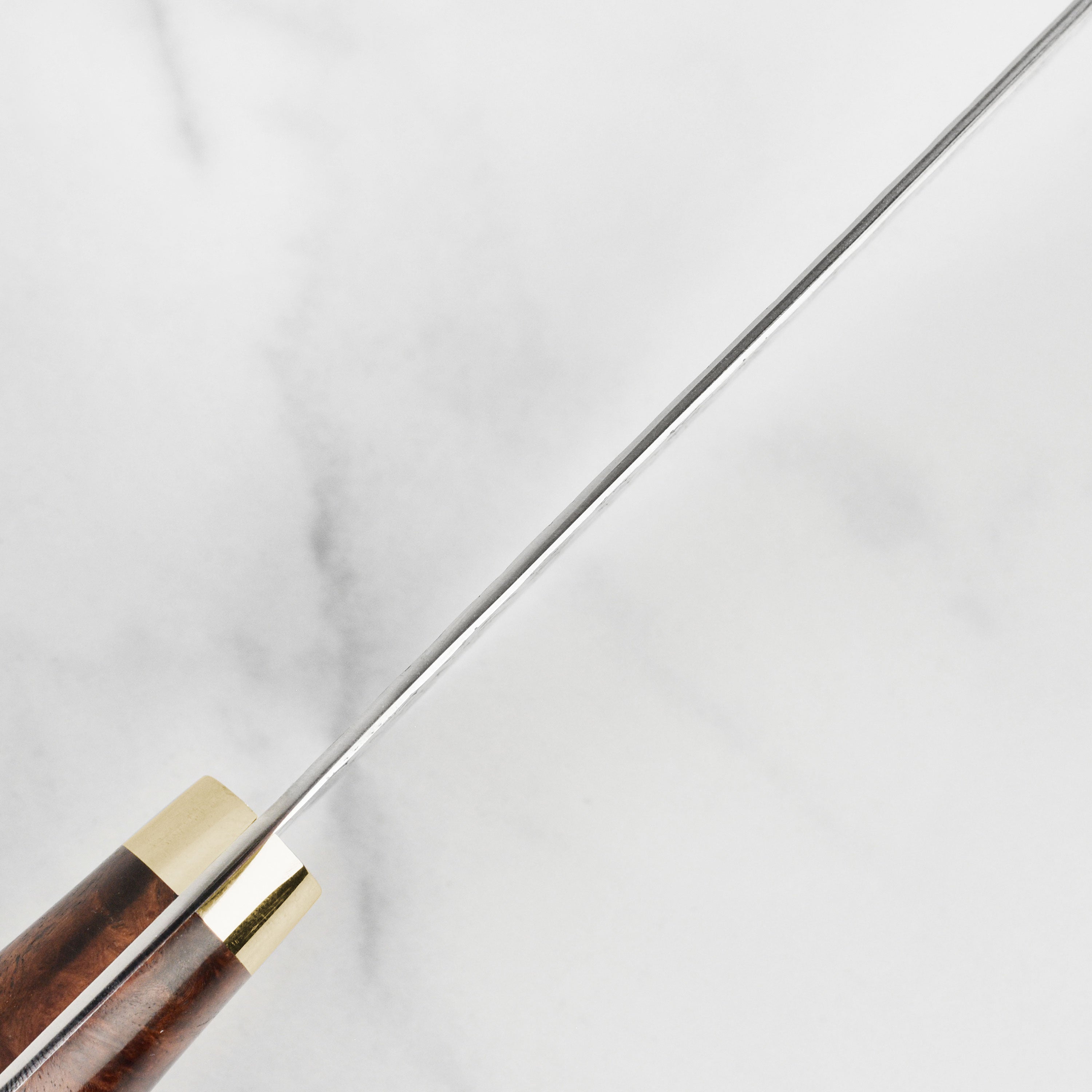 Close-up of the Quince Wood handle of the Yoshimi Kato Minamo SG2 knife, emphasizing its texture and finish.