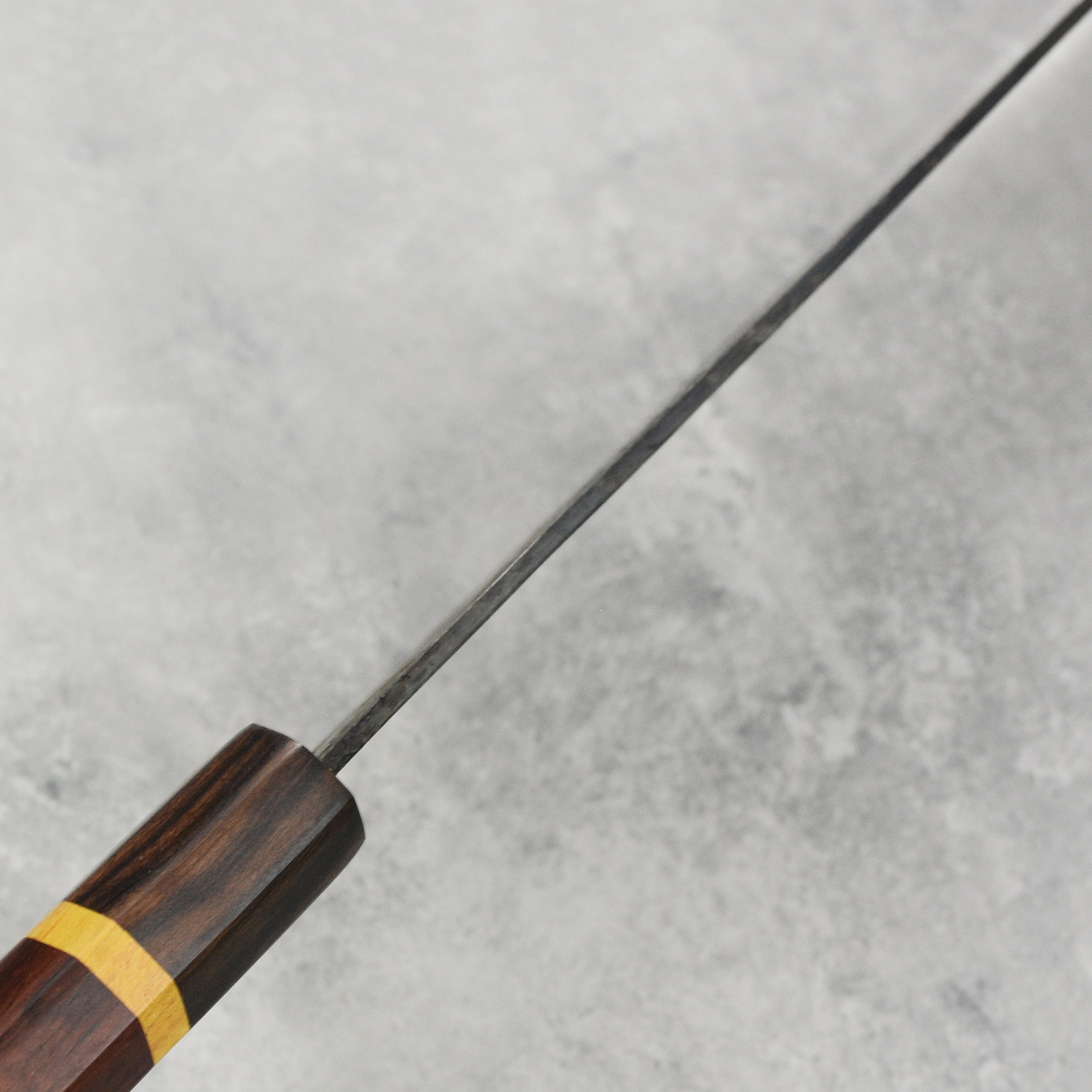 Close-up of Dao Vua V3 gyuto knife highlighting its premium carbon steel quality.