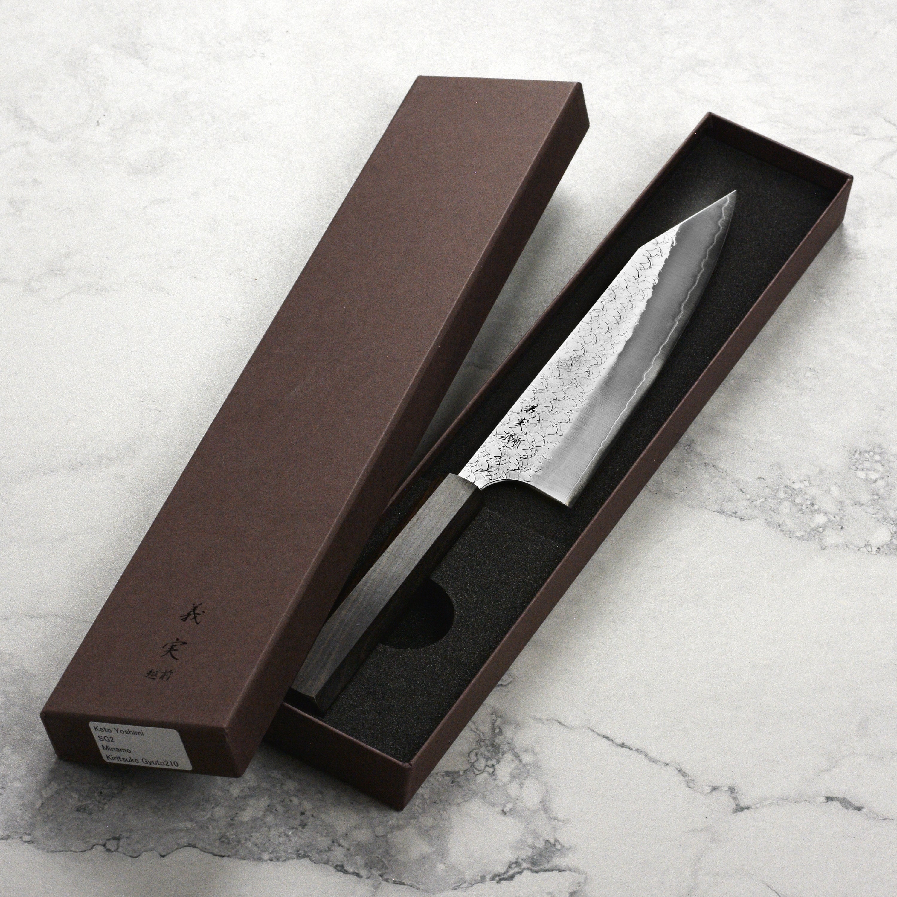 Close-up of Minamo SG2 Kiritsuke knife blade, highlighting its sharp edge and craftsmanship.