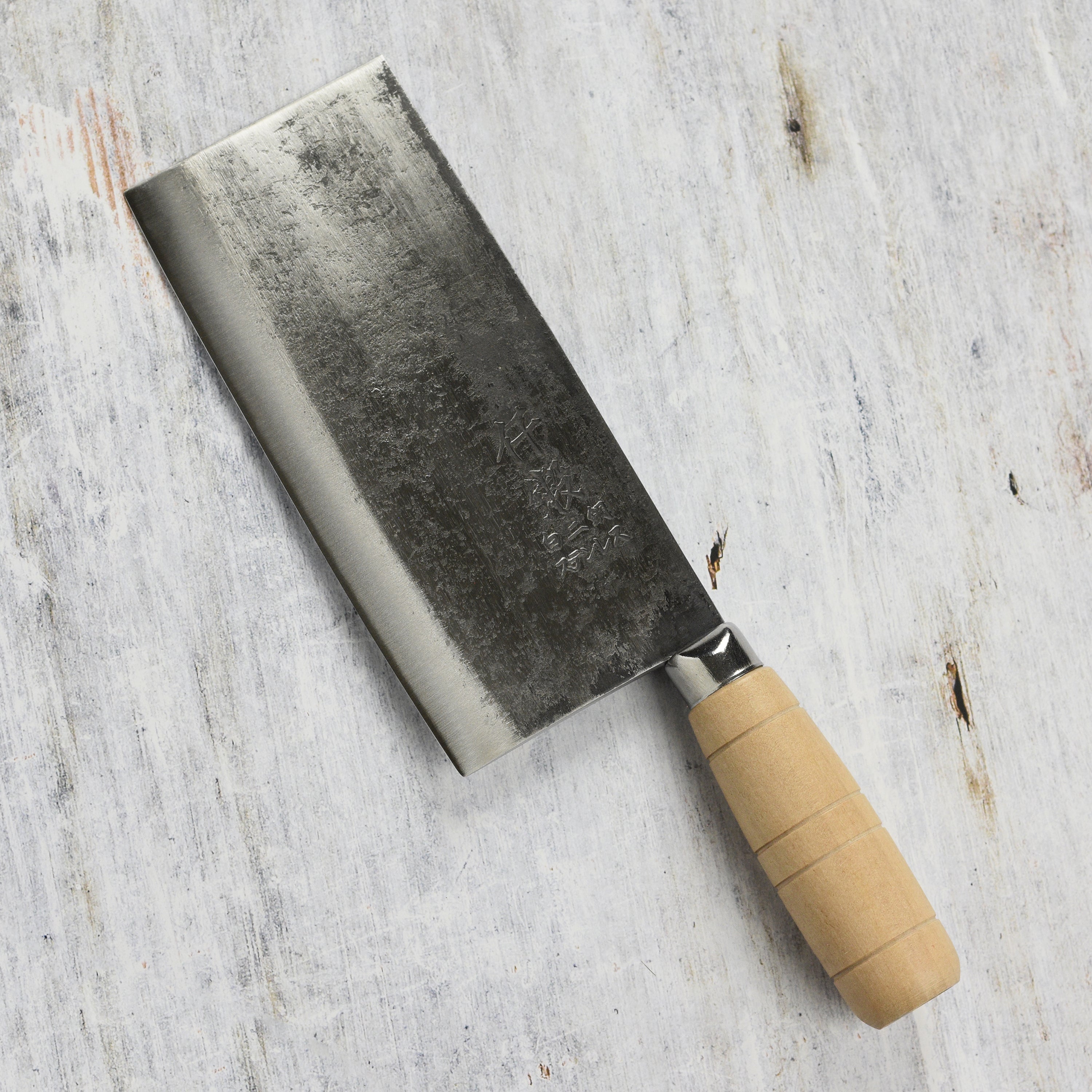 Angle view of the carbon steel knife in action, slicing through vegetables for meal prep.