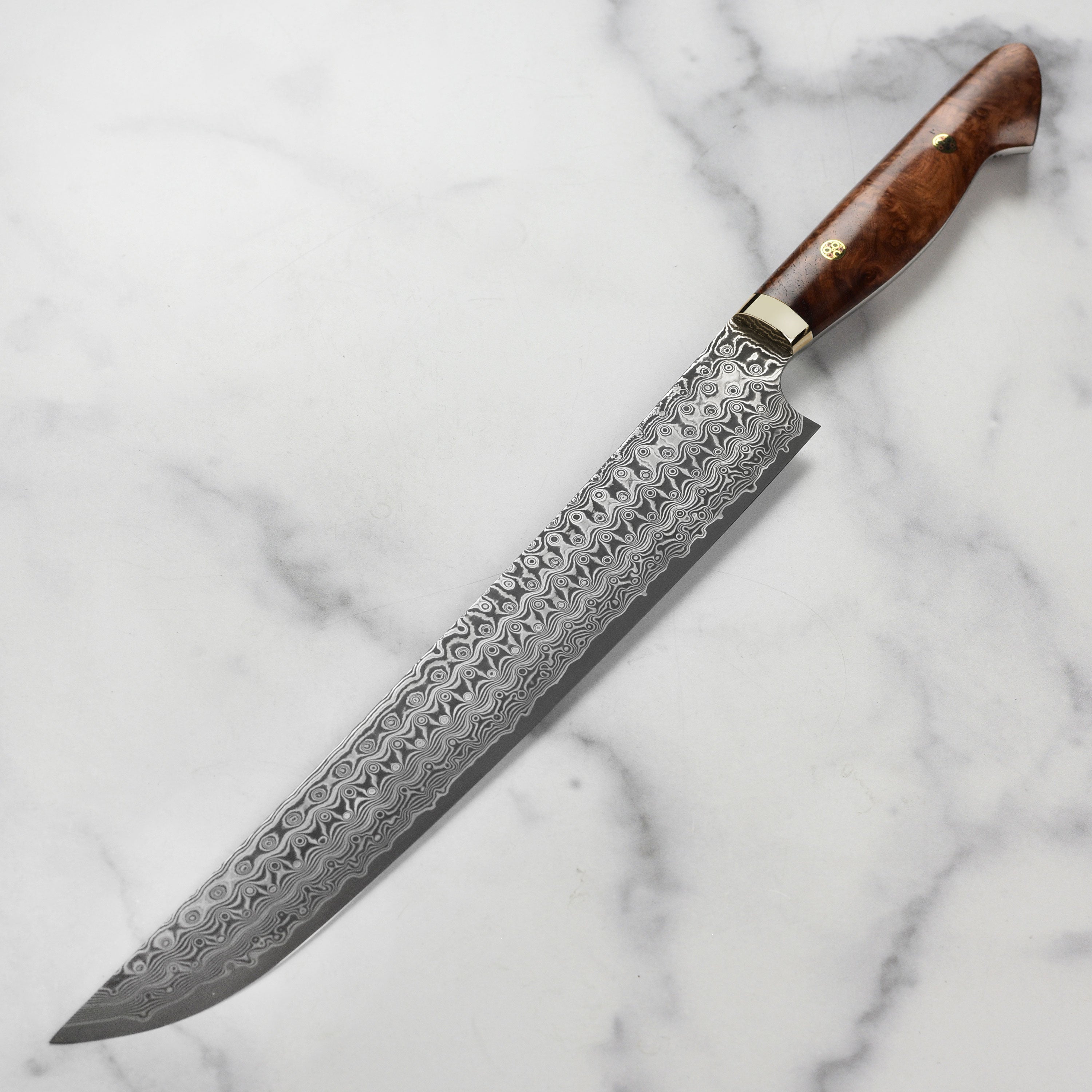 Professional chef slicing meat with Nigara sujihiki knife in kitchen