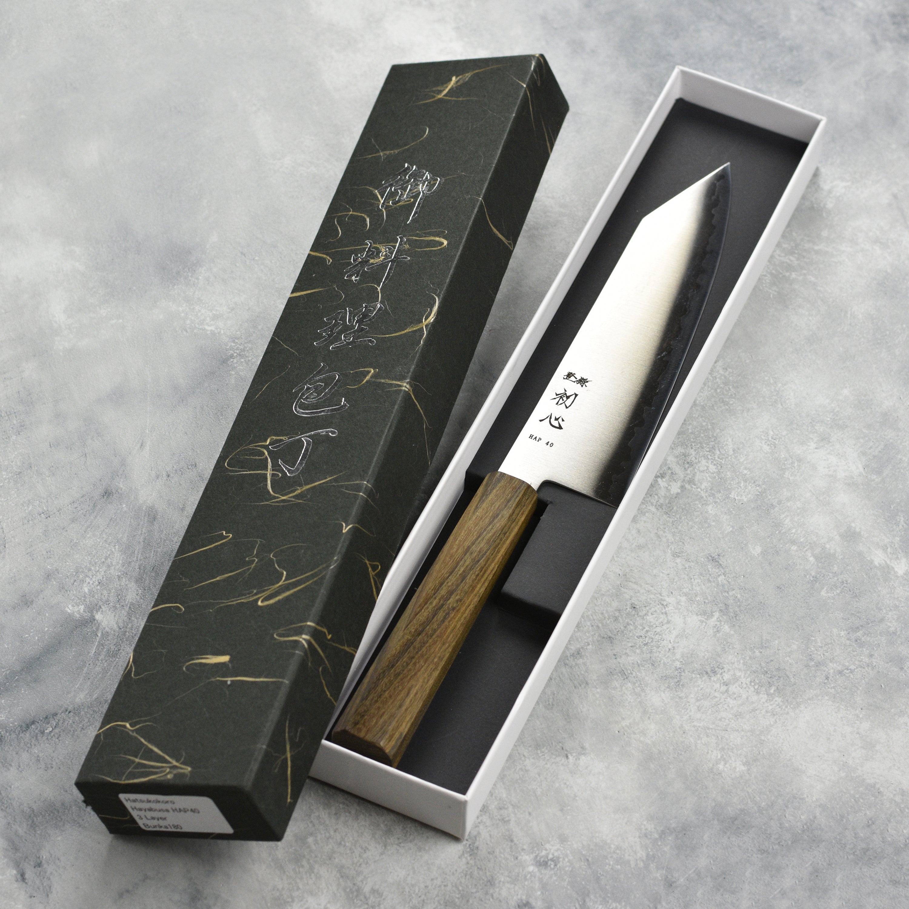 Hatsukokoro Hayabusa HAP40 bunka knife in a kitchen setting highlighting its sharp edge
