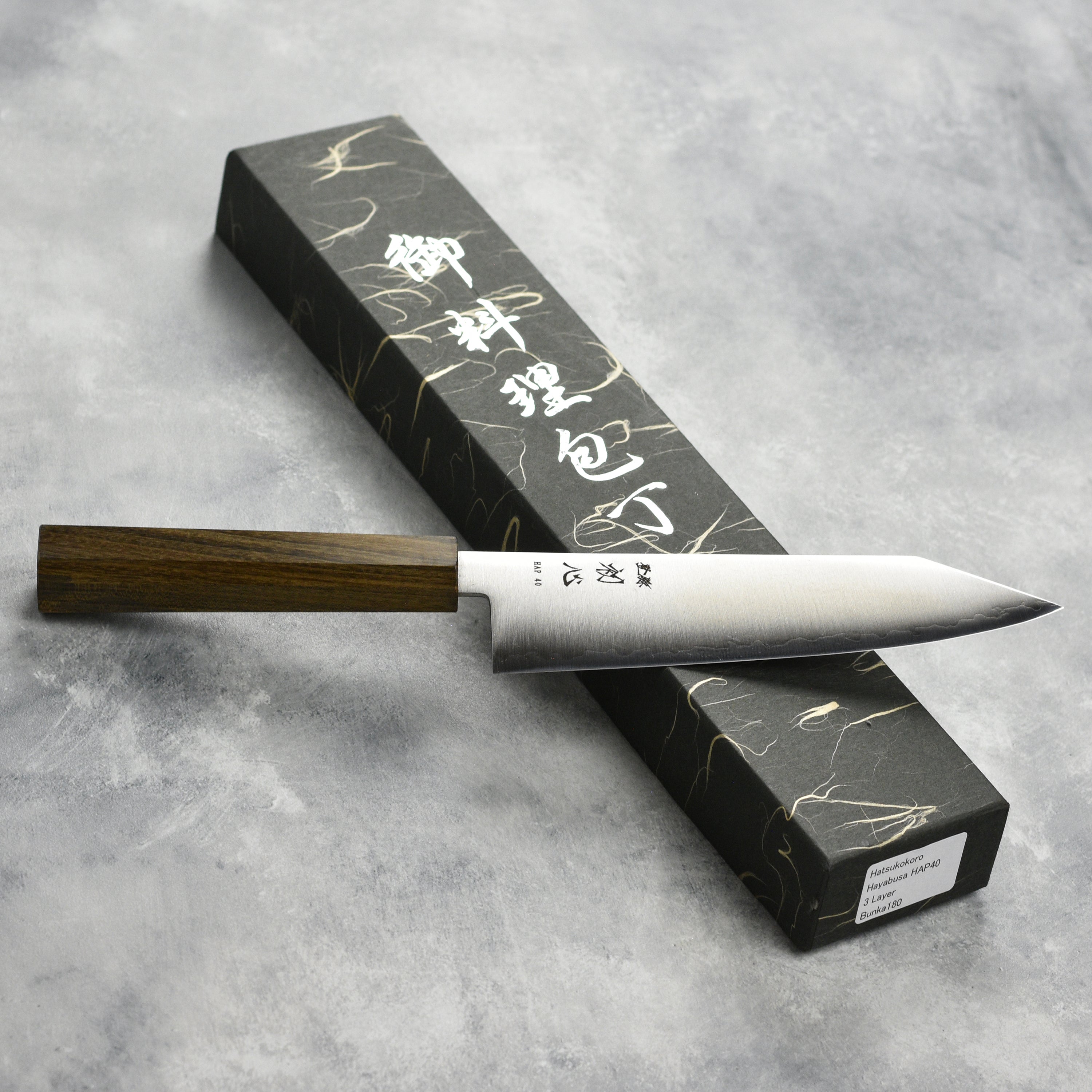 Hatsukokoro Hayabusa HAP40 bunka knife in a kitchen setting highlighting its sharp edge