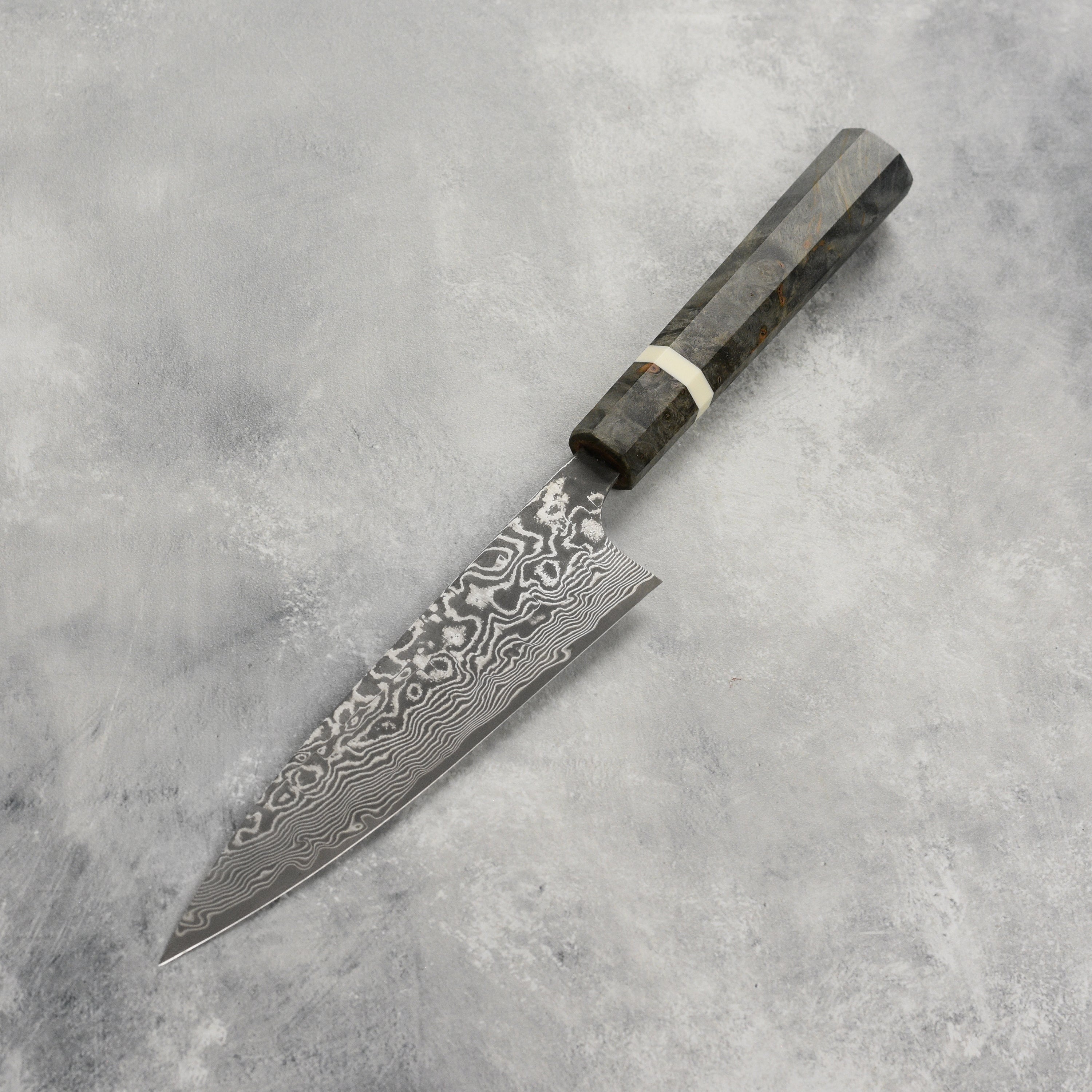 Saji Petty Knife in use, slicing vegetables for a gourmet meal