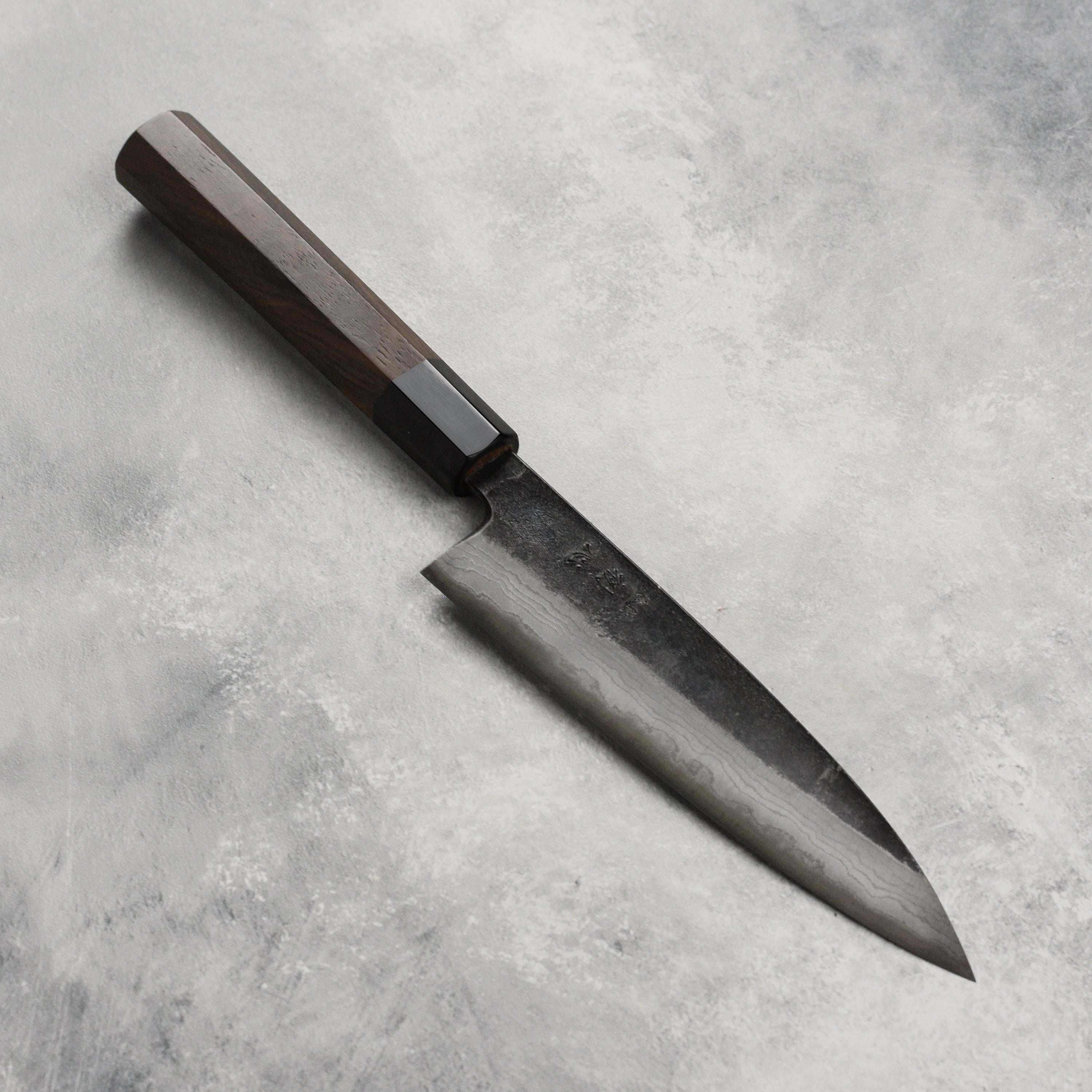 Hatsukokoro Premium Damascus Petty Knife from the side, highlighting the blade's craftsmanship.