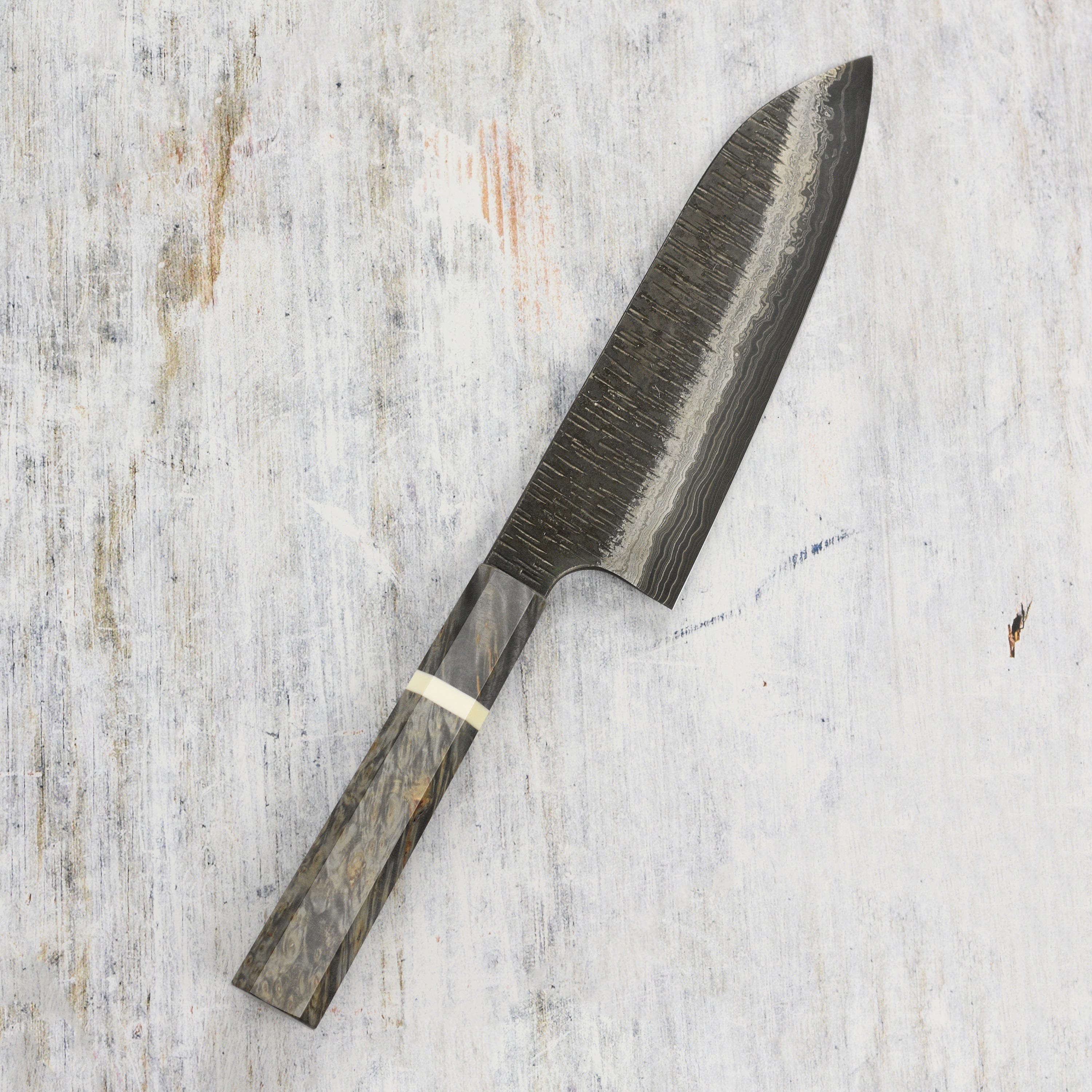 Close-up of the Damascus steel pattern on the Santoku knife for detailed craftsmanship.