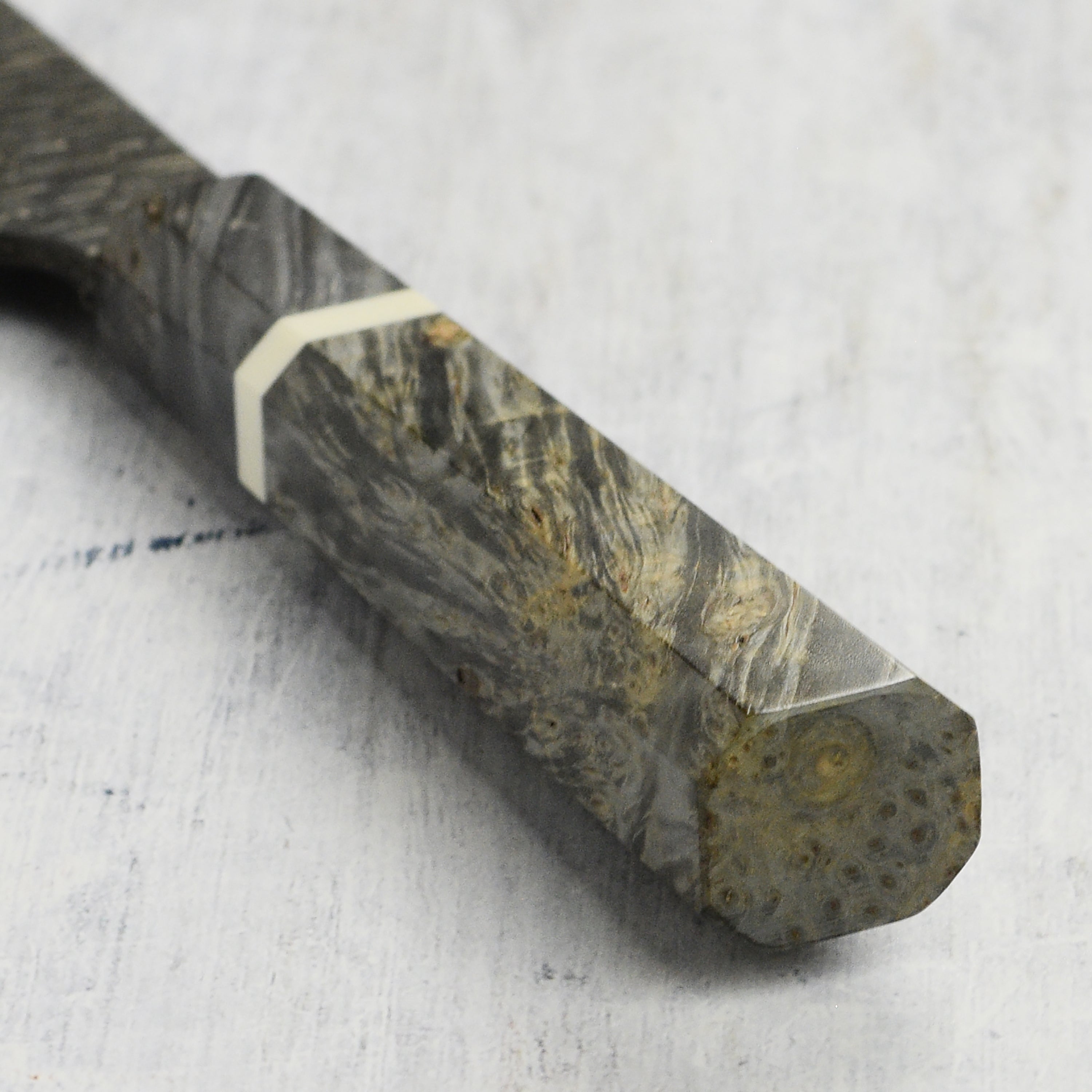 Close-up of the Damascus steel pattern on the Santoku knife for detailed craftsmanship.