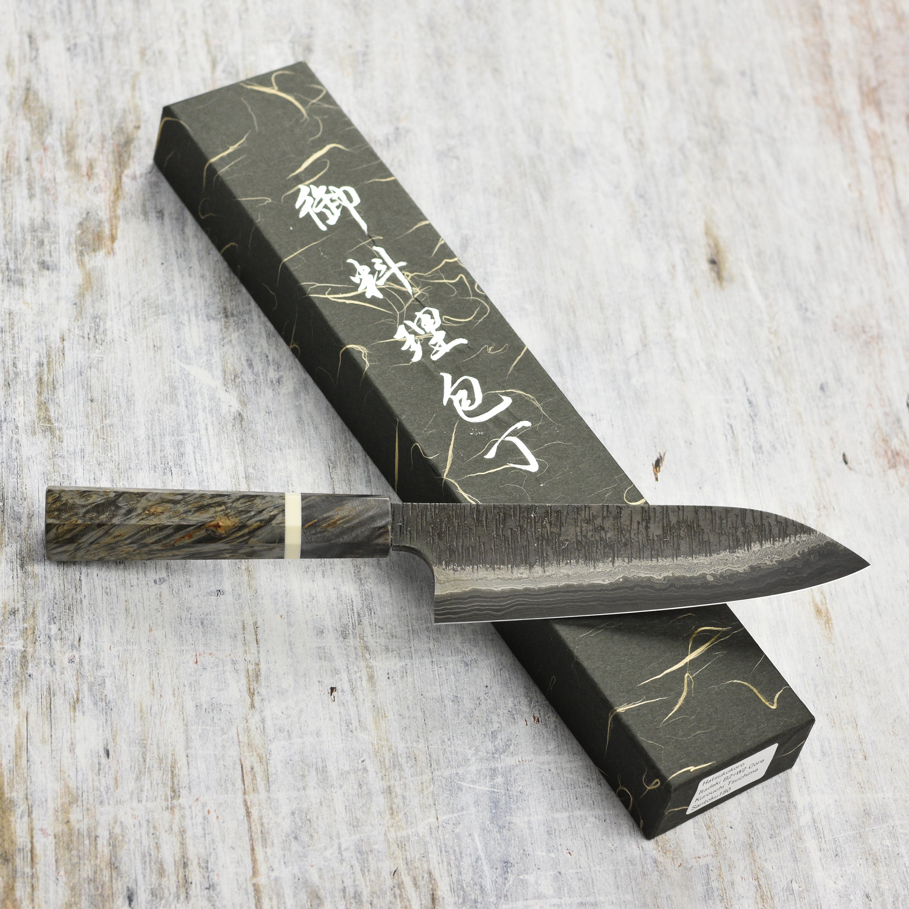 Front view of the Hatsukokoro Nigara 7-inch Damascus Santoku knife showcasing its blade and handle.