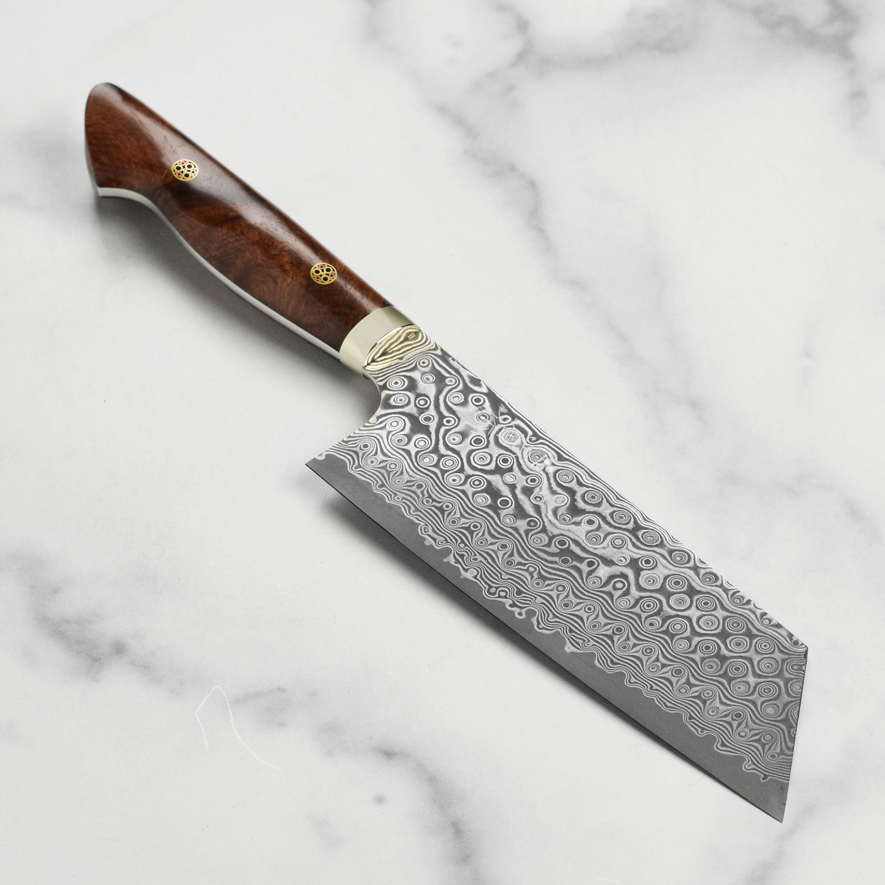 Nigara Anmon SG2 Damascus Kiritsuke knife with quince wood handle, angled view.