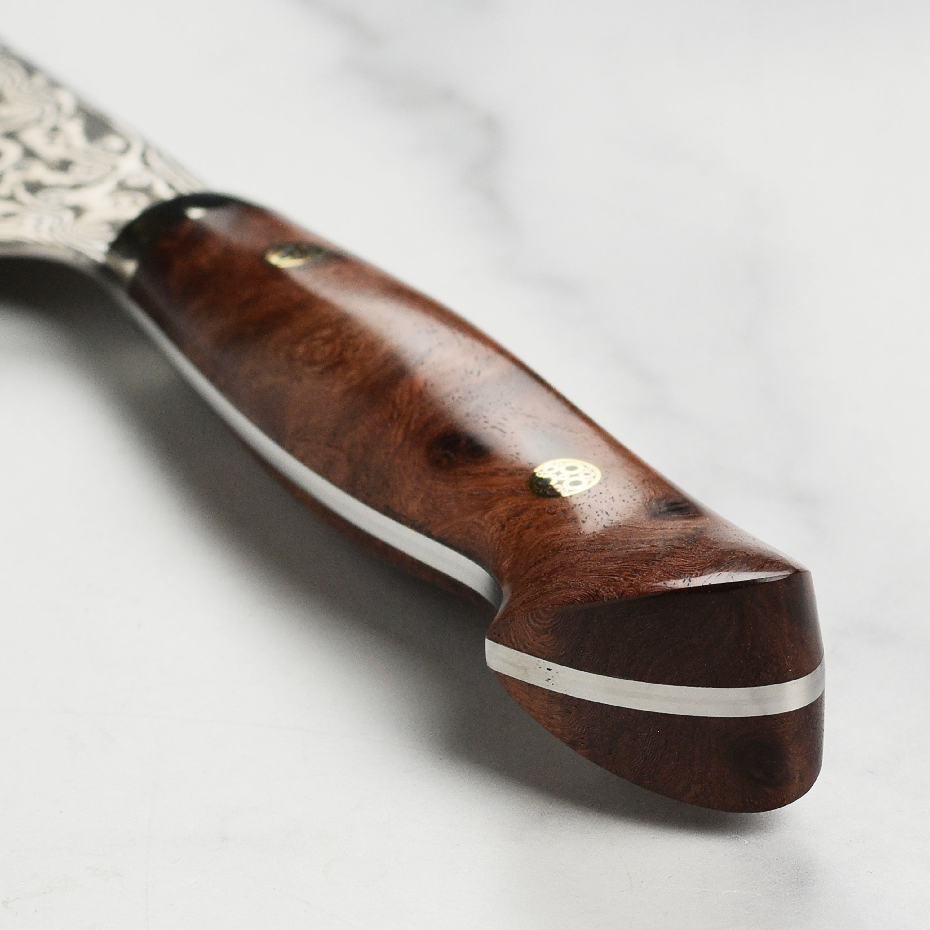 Professional chefs using the Nigara Anmon SG2 Damascus knife in a modern kitchen setting.