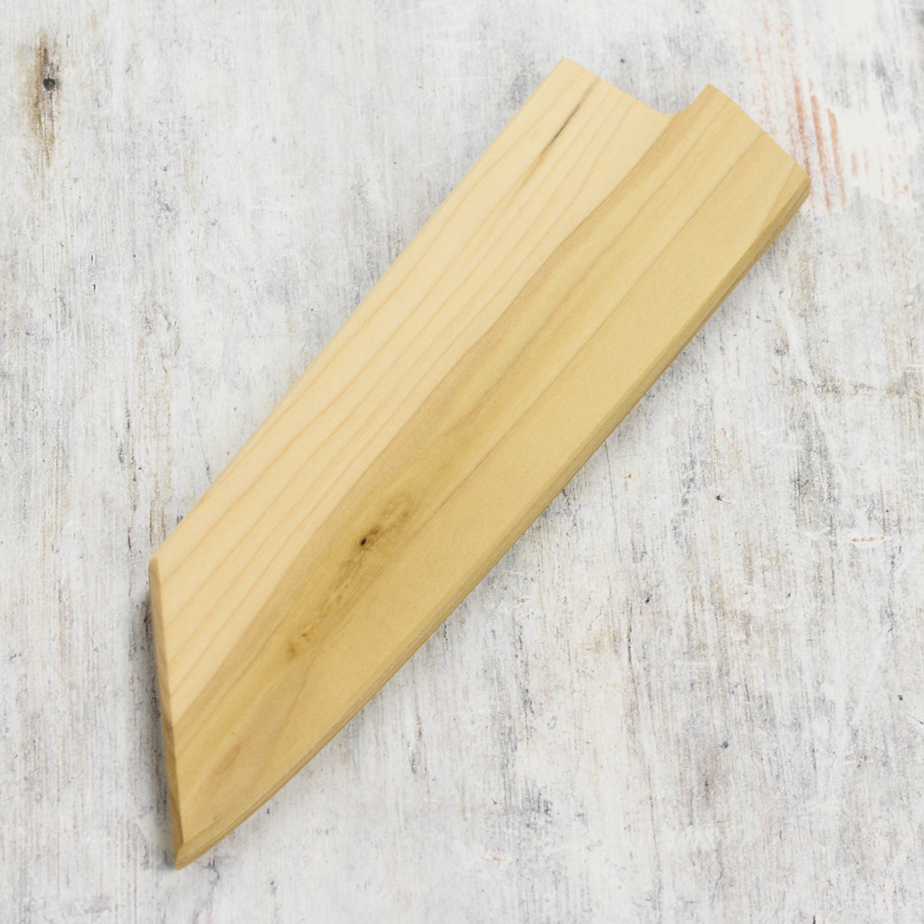 Angled side photo highlighting the poplar wood grain of the knife sheath