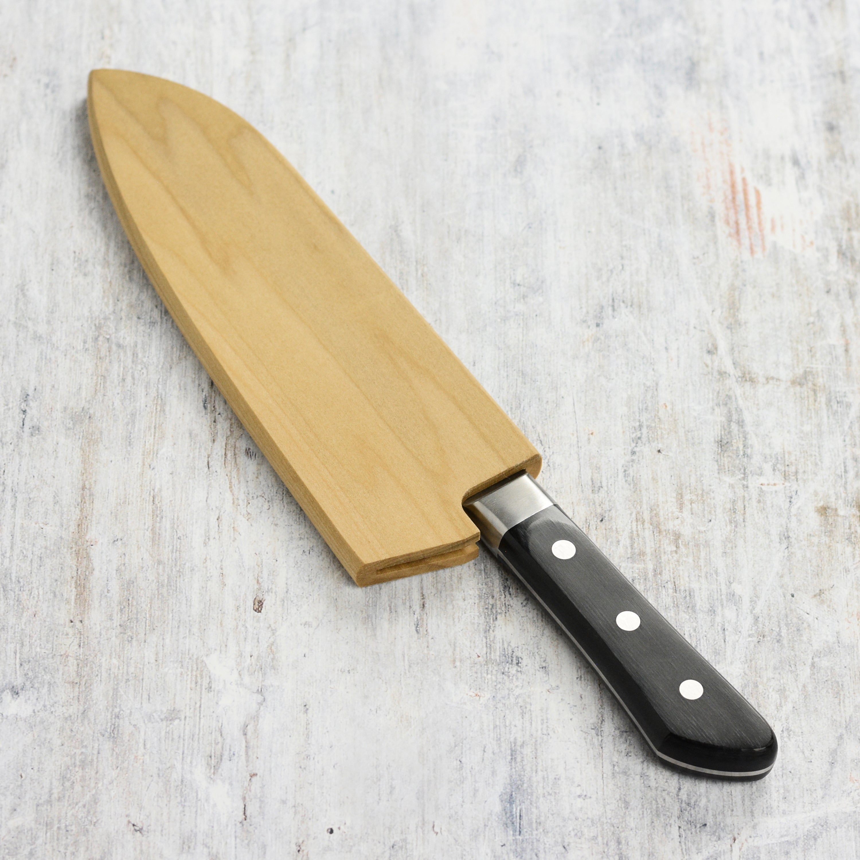 Premium magnetic knife holder showcasing a 6.5" Santoku knife securely held in place, highlighting its elegant design.