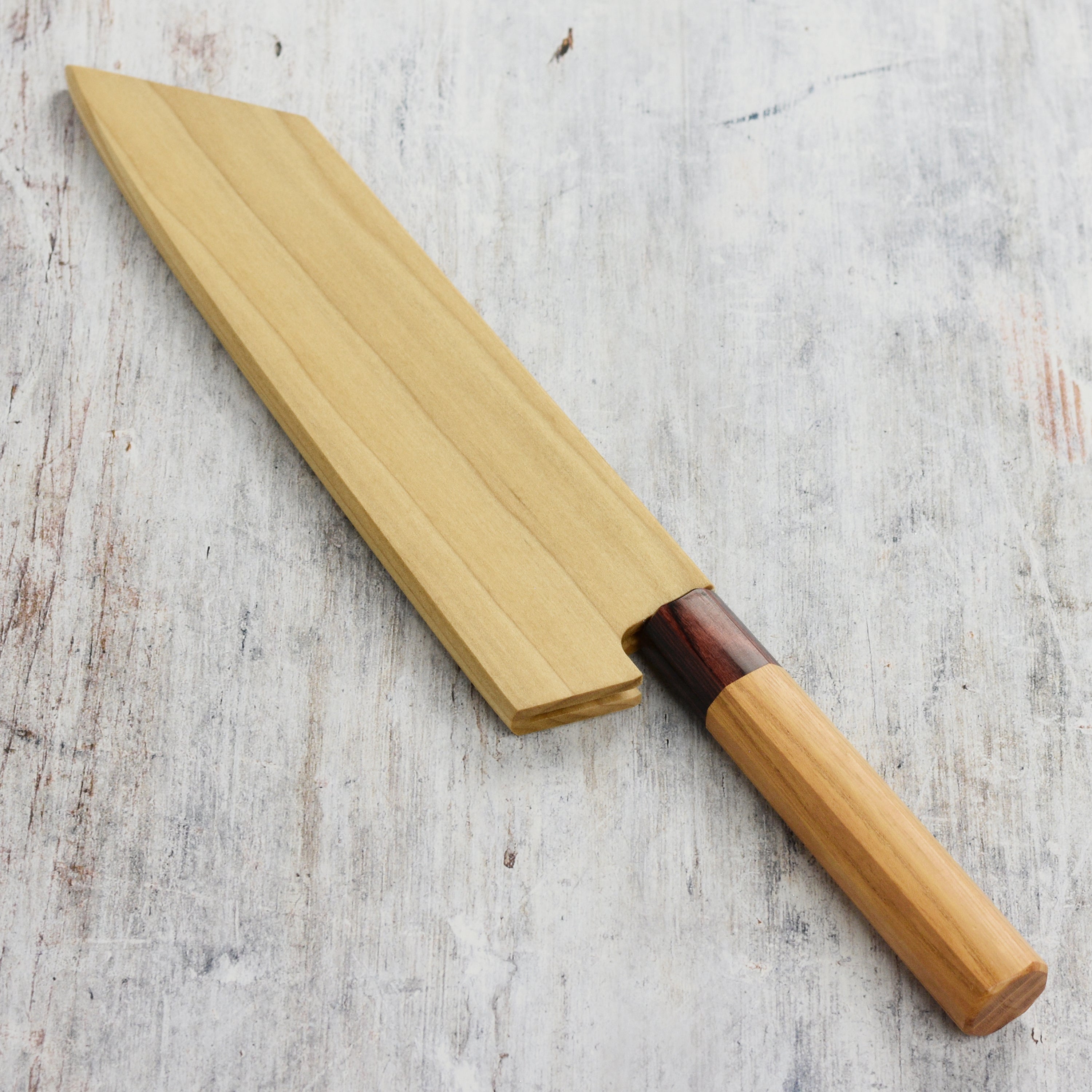 Top angle view of the kiritsuke knife sheath showing poplar wood grain and magnetic grip