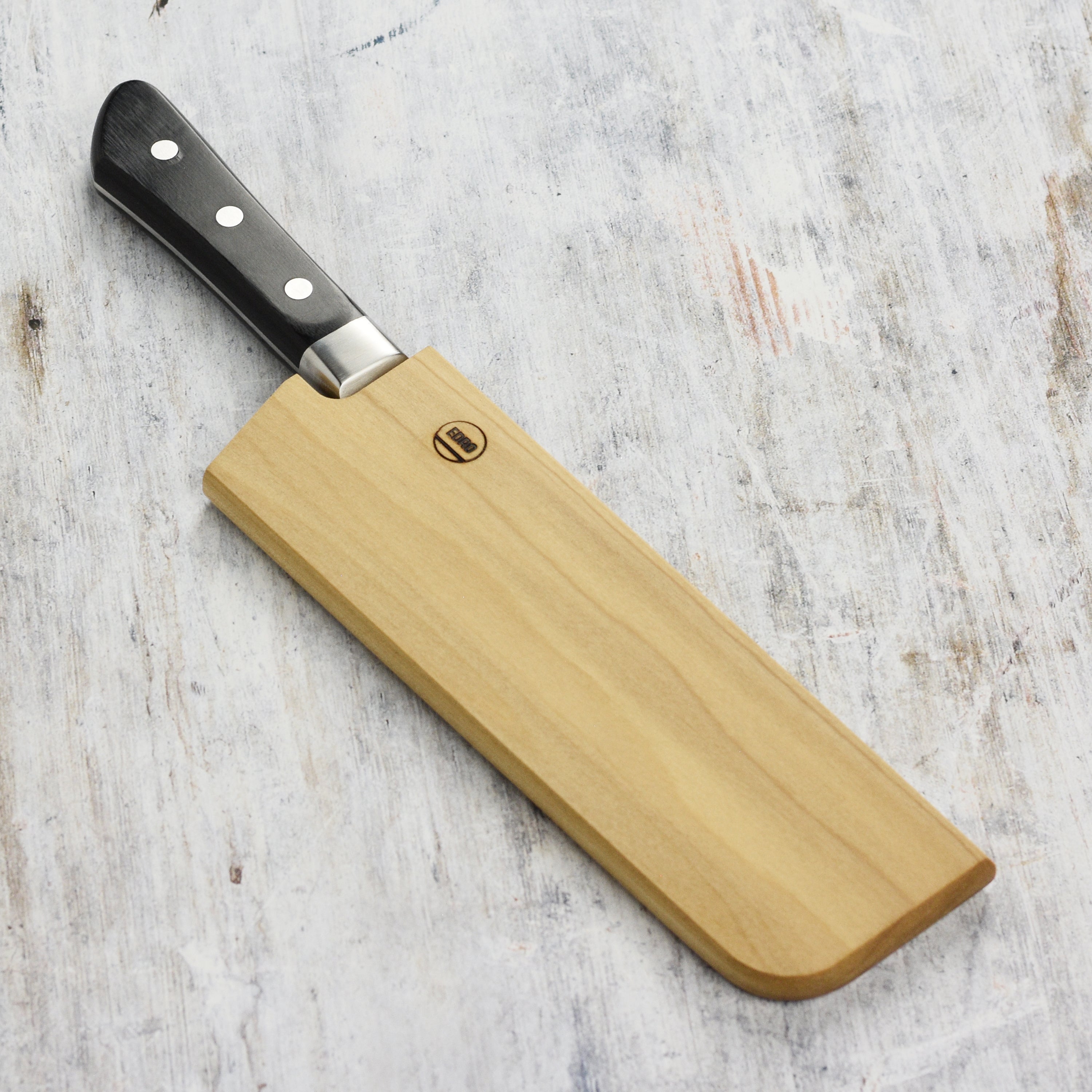 Close-up of the Edro magnetic saya holding a 6.5-inch Nakiri Japanese knife