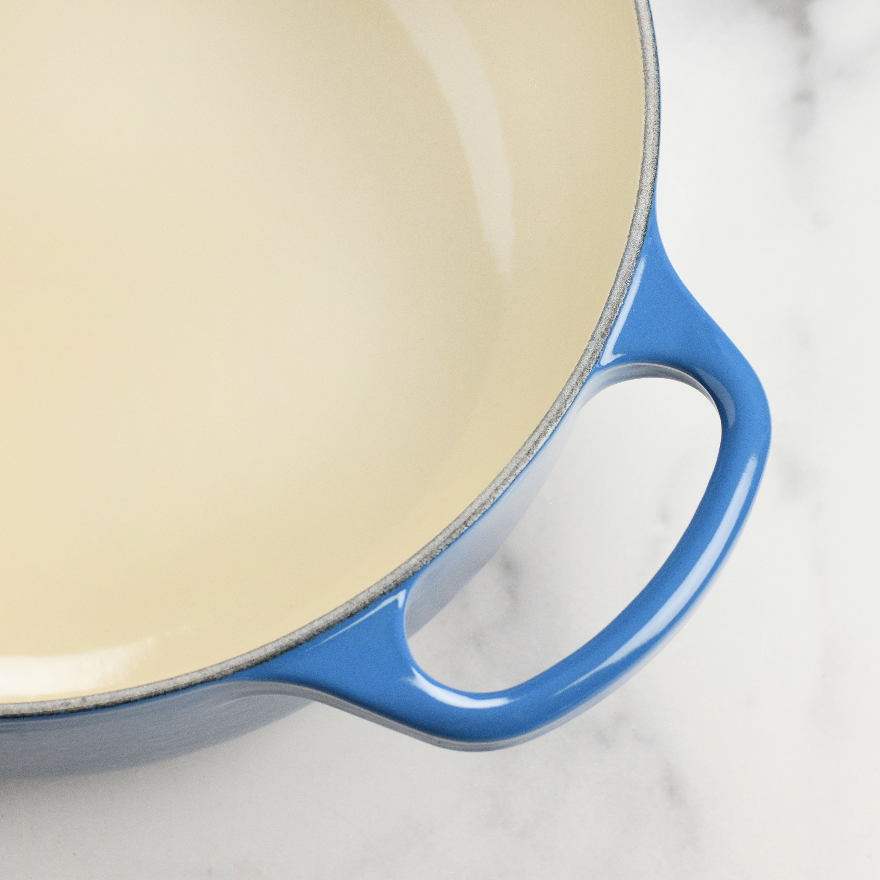 Le Creuset Marseille 3.5-quart enameled cast iron Dutch oven on stovetop, showcasing its durable enamel and ergonomic handles