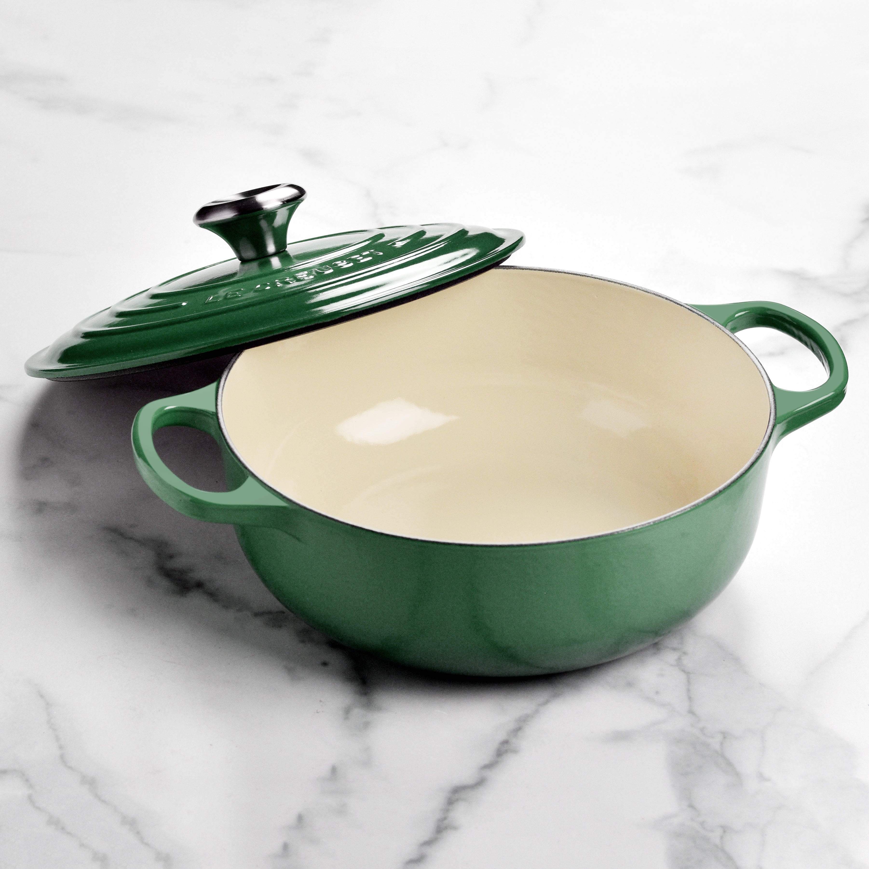 Le Creuset cast iron Dutch oven with enamel finish on a stovetop, showcasing its durable design