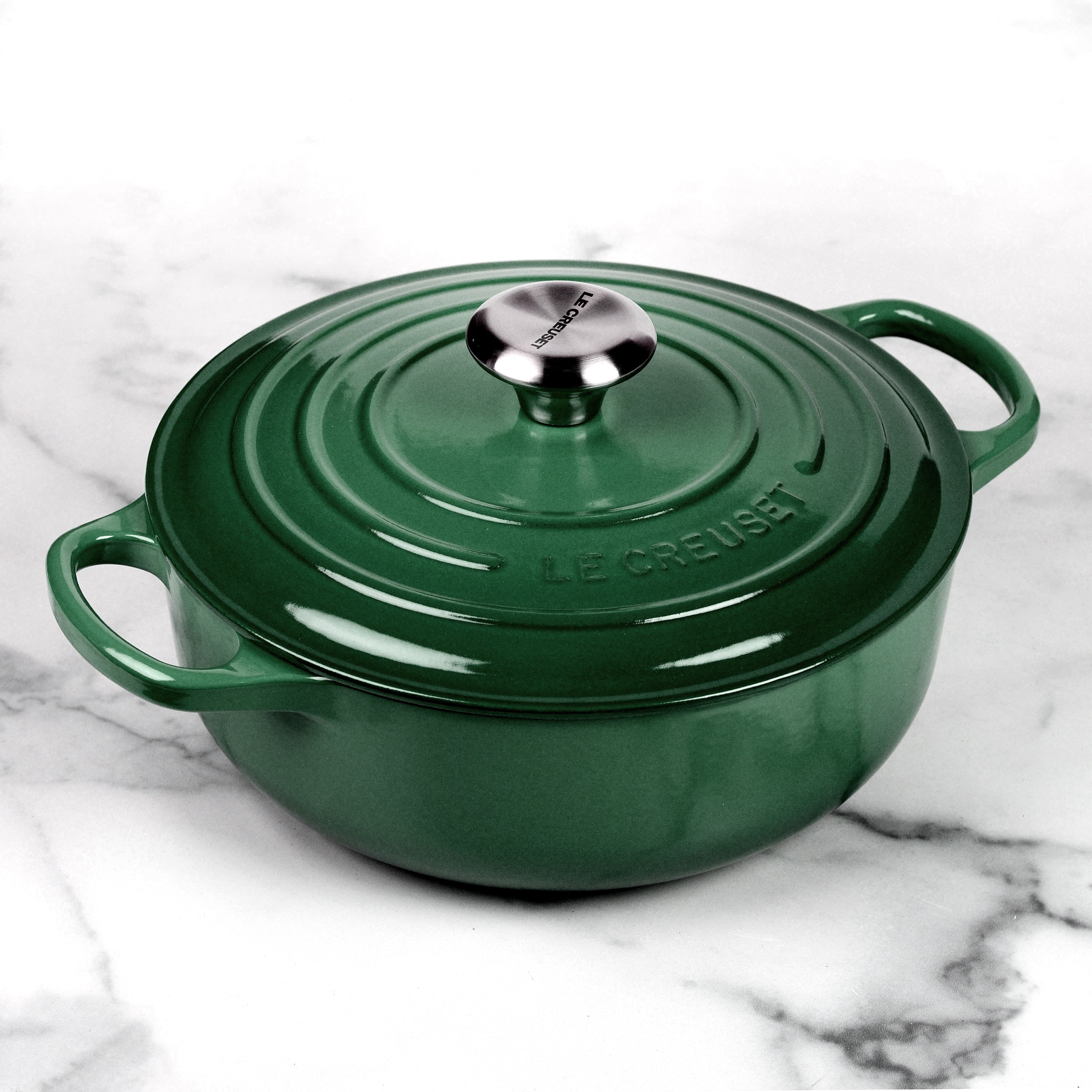 Le Creuset cast iron Dutch oven with enamel finish on a stovetop, showcasing its durable design