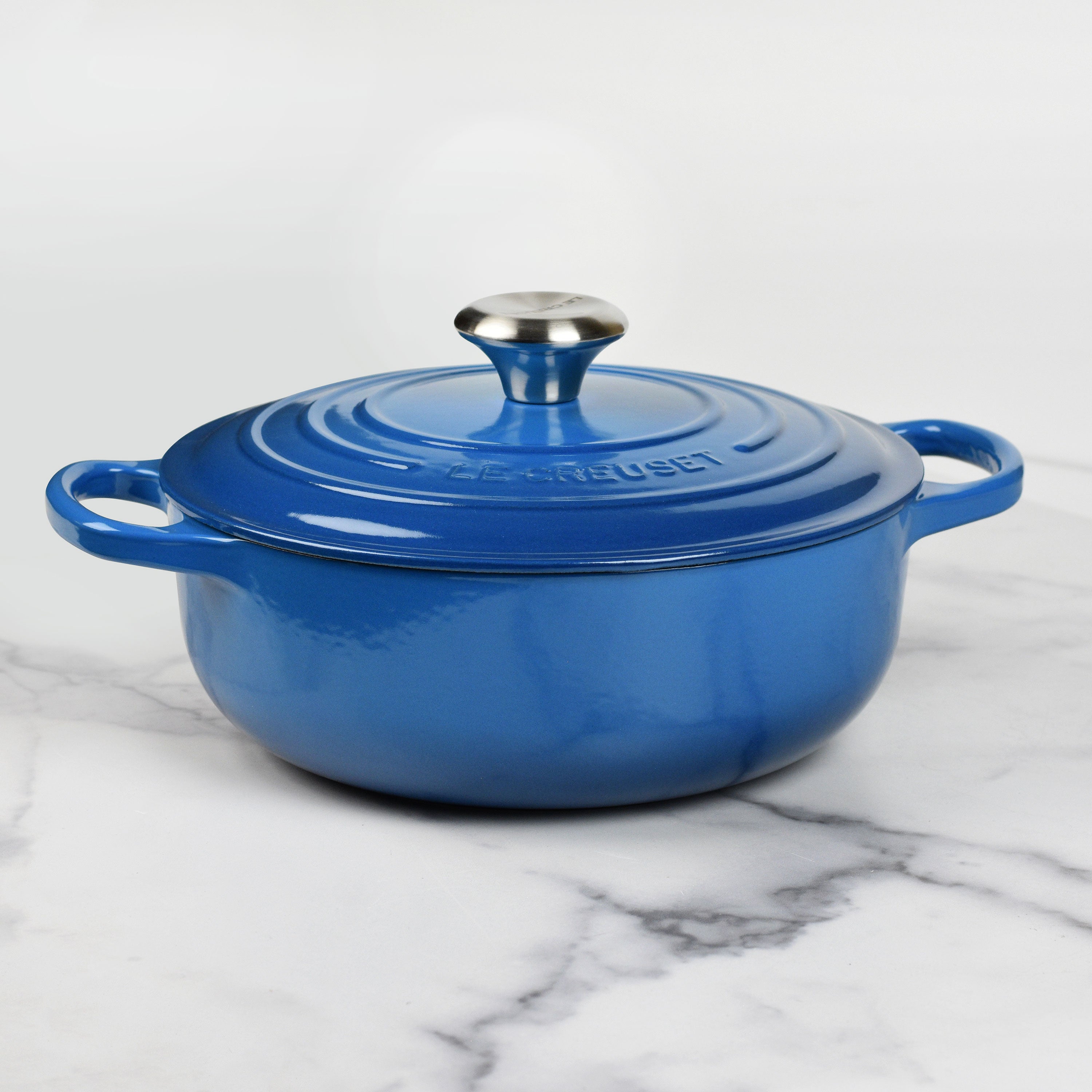 Le Creuset Marseille 3.5-quart enameled cast iron Dutch oven on stovetop, showcasing its durable enamel and ergonomic handles