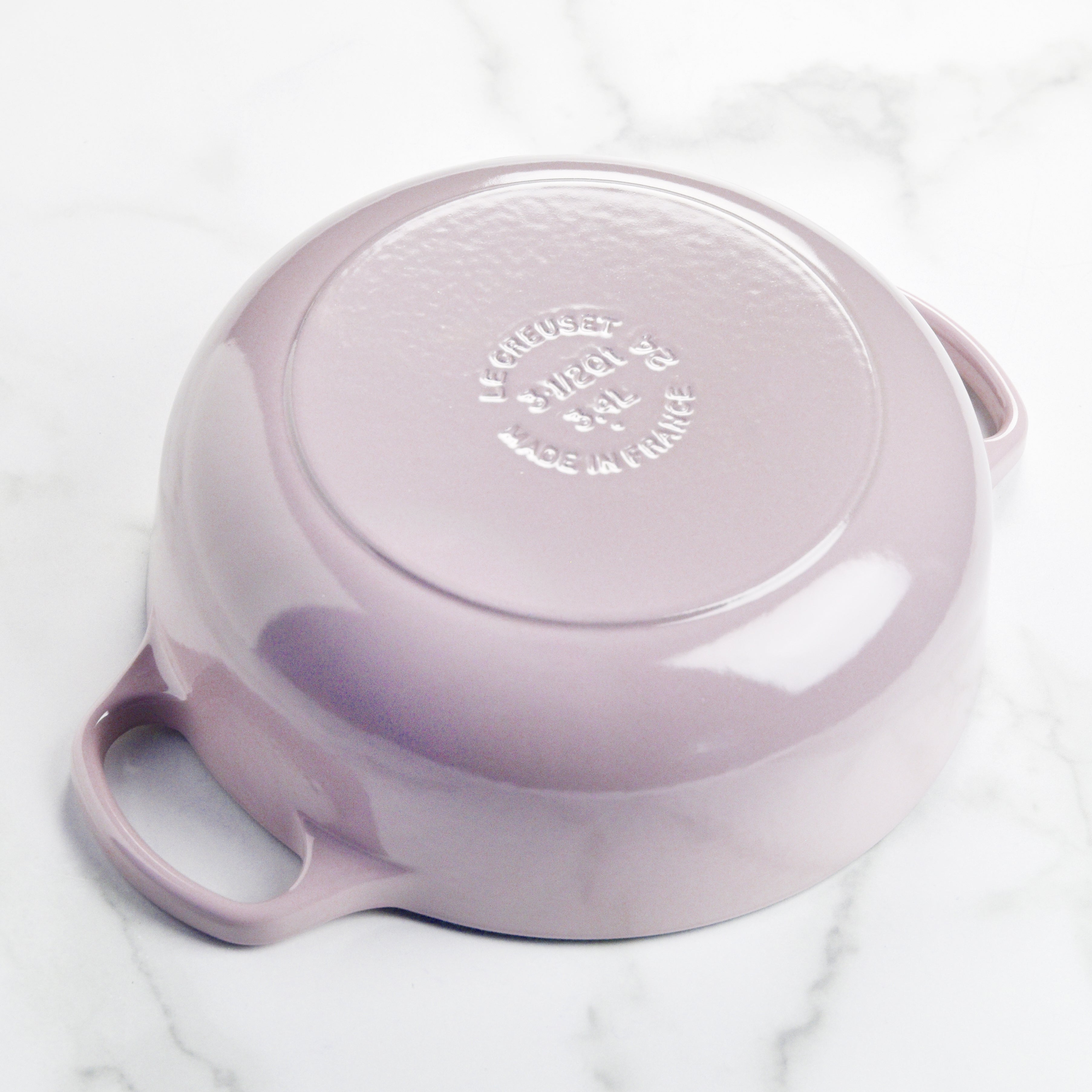 Le Creuset cast iron Dutch oven on a gas stovetop, highlighting its compatibility with all cooking surfaces.