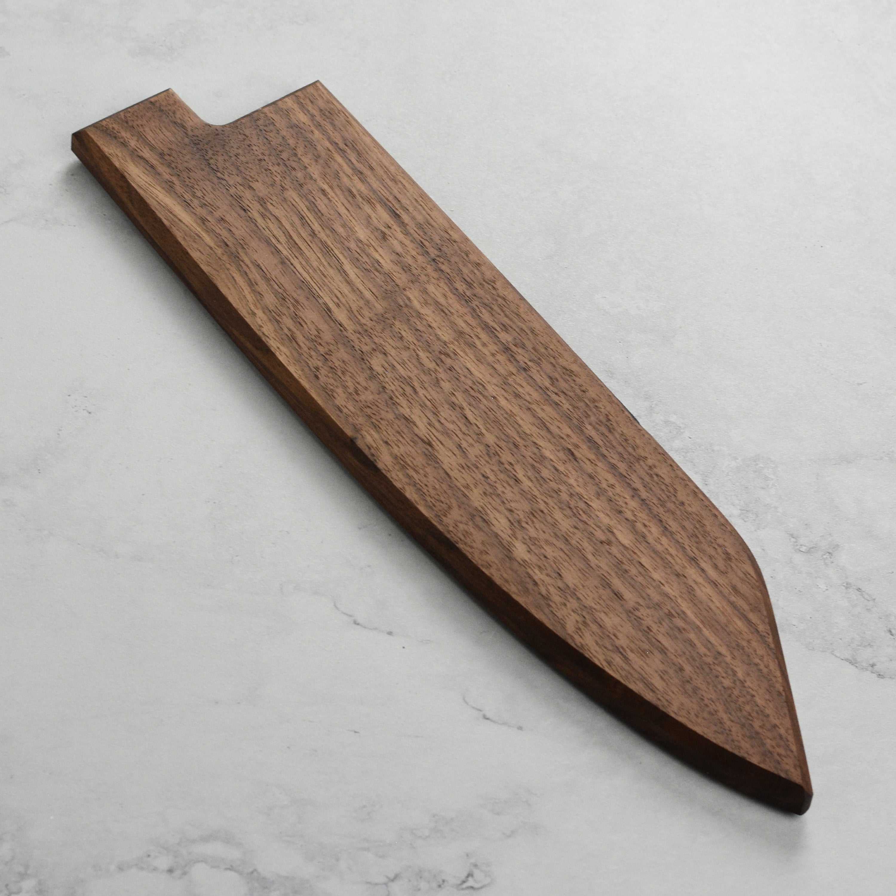Close-up of the walnut magnetic knife saya holding a 9.4