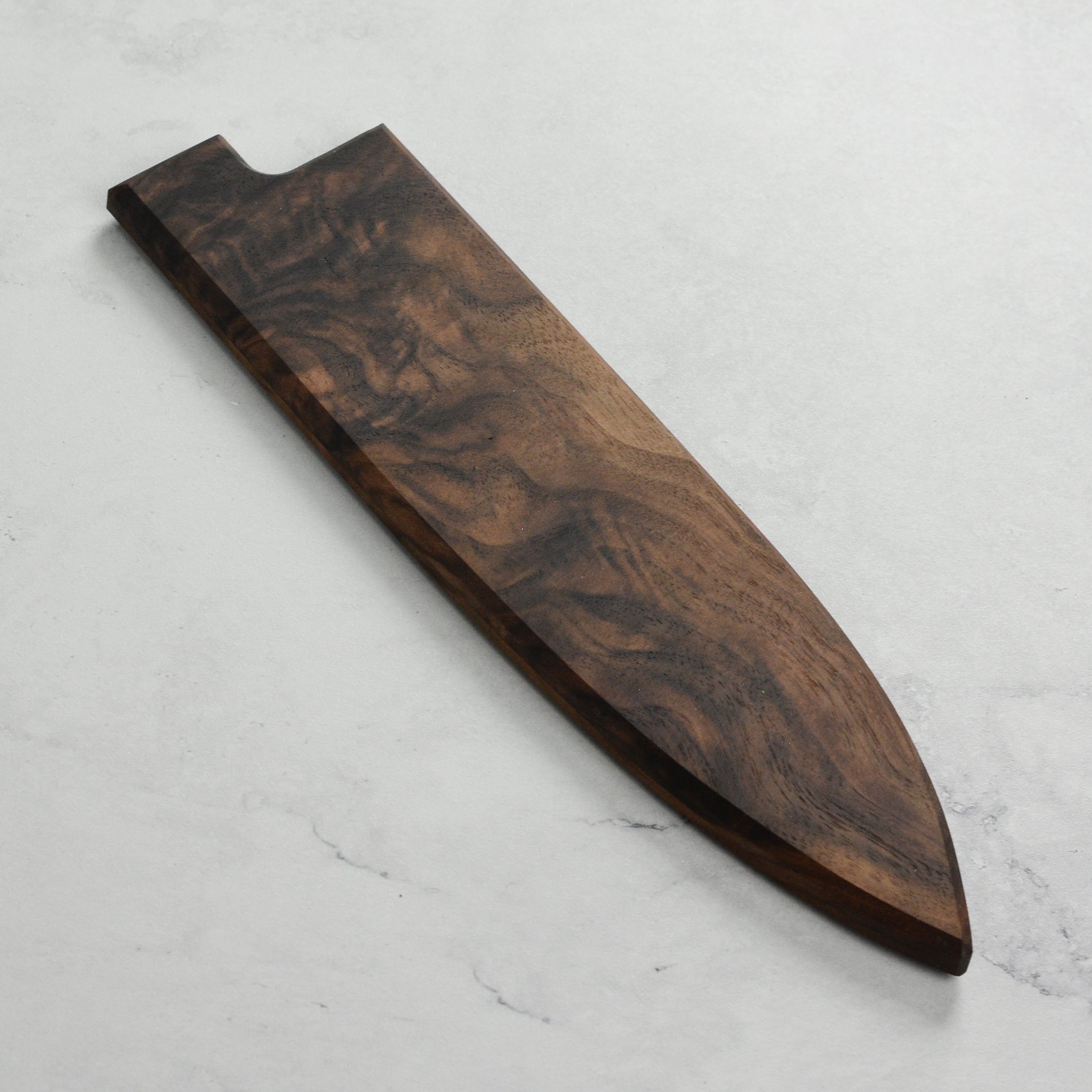 Close-up of walnut magnetic saya showing smooth grain and hidden magnetic closure