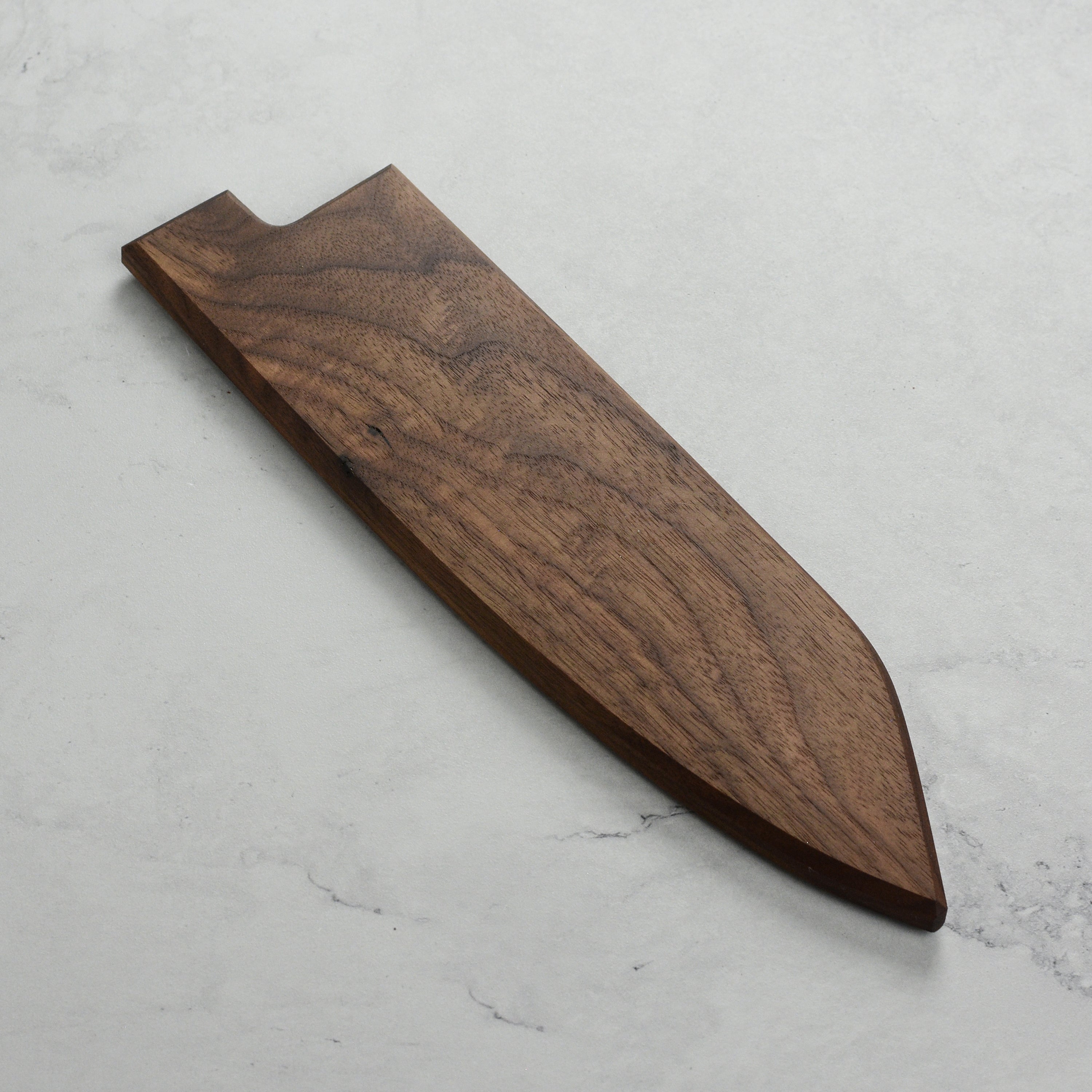 Premium walnut magnetic knife saya showcasing its smooth finish and embedded magnets.