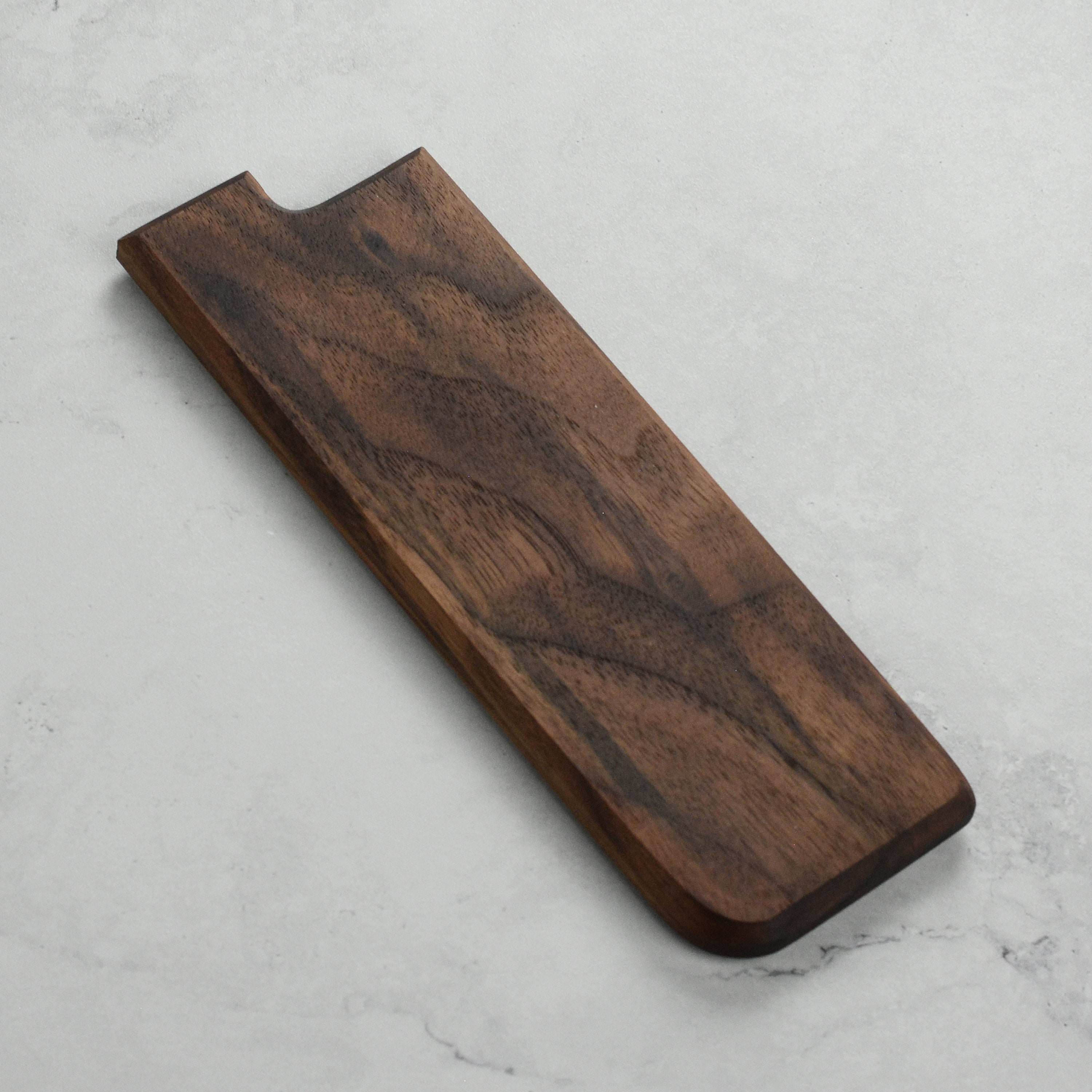 Walnut magnetic saya showing the embedded magnets and smooth finish.