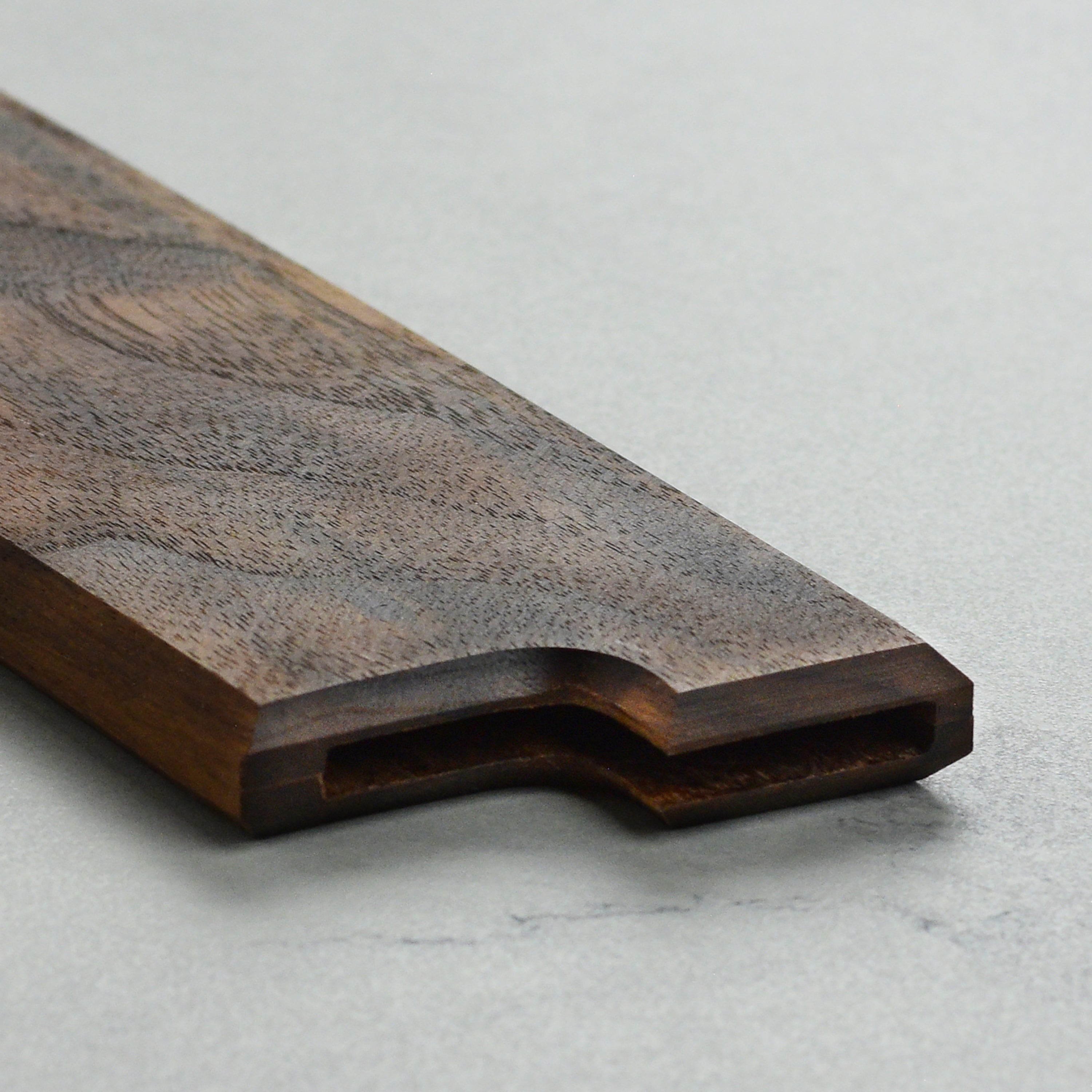 Walnut magnetic saya showing the embedded magnets and smooth finish.