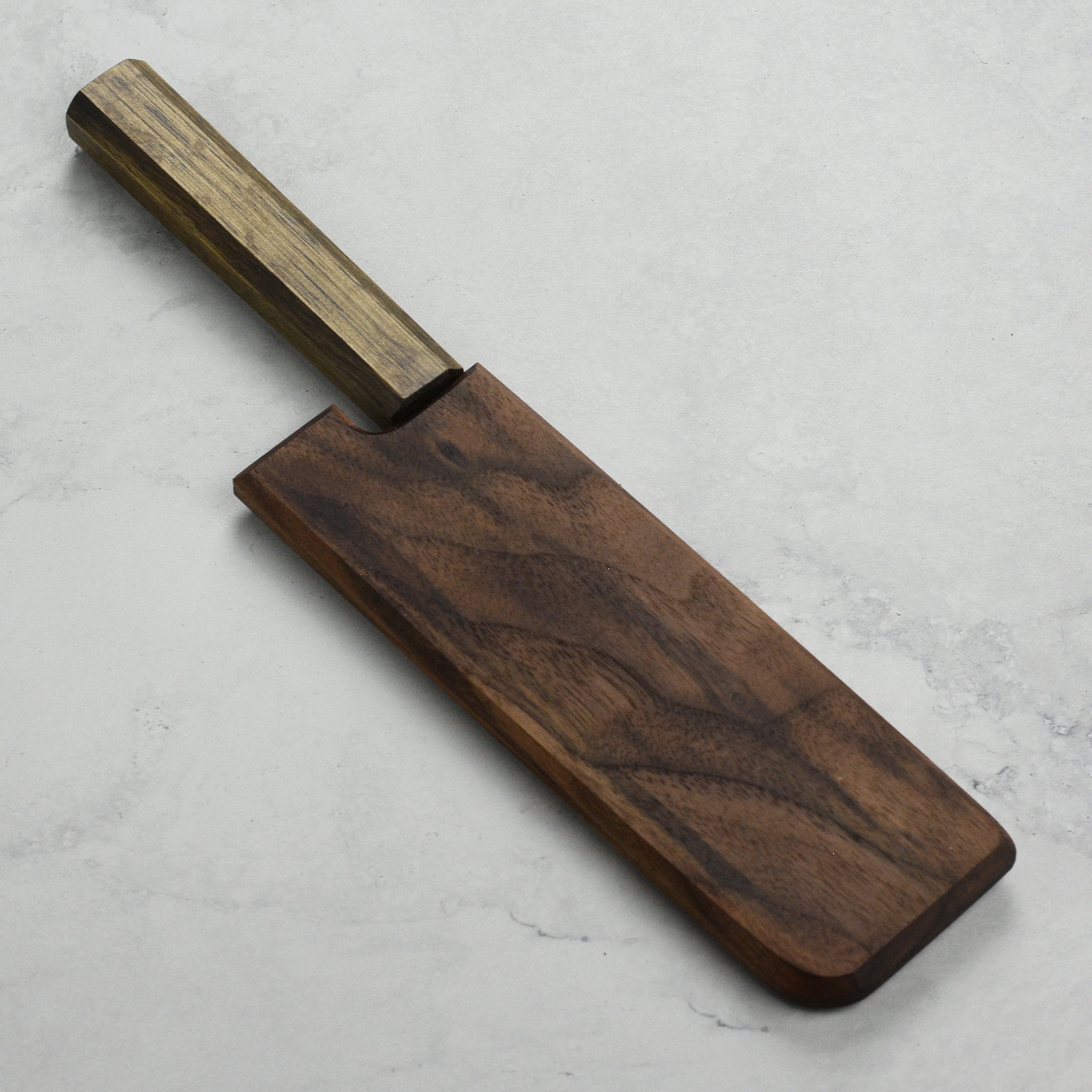 Close-up of walnut saya with a nakiri knife securely held in place.