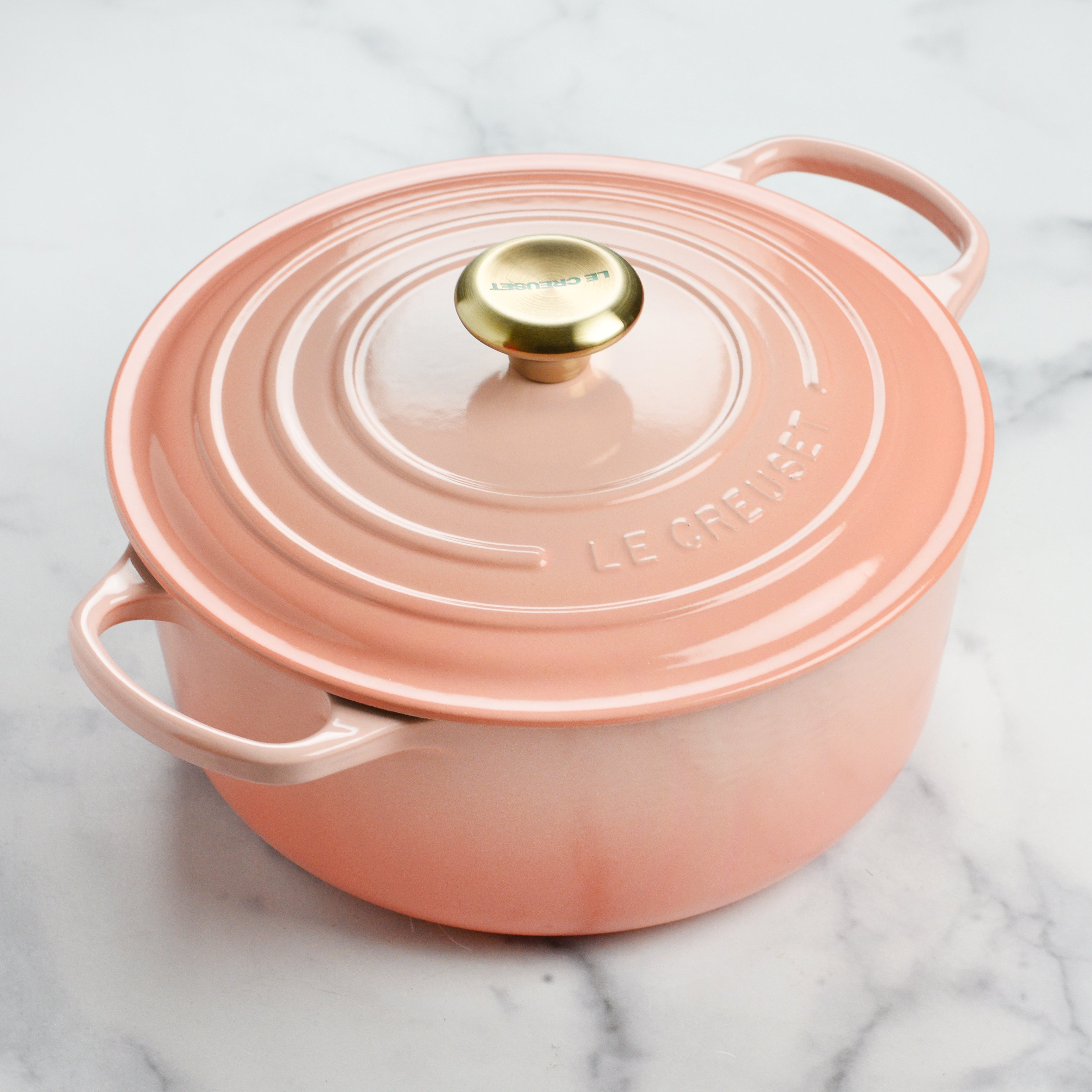 Le Creuset cast iron Dutch oven with Peche color, front view, ideal for slow cooking