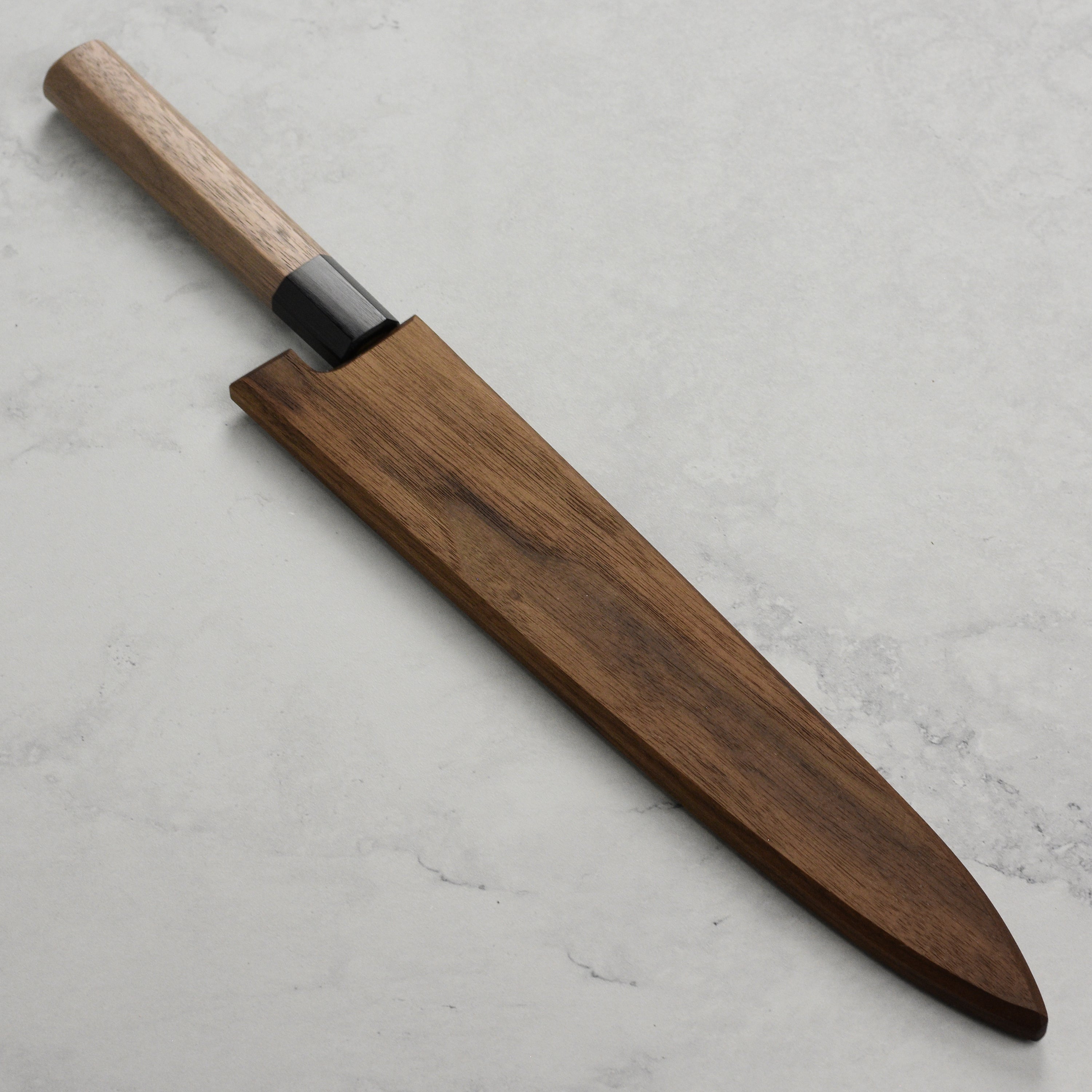 Closeup of magnetic edge showing embedded magnets inside walnut saya