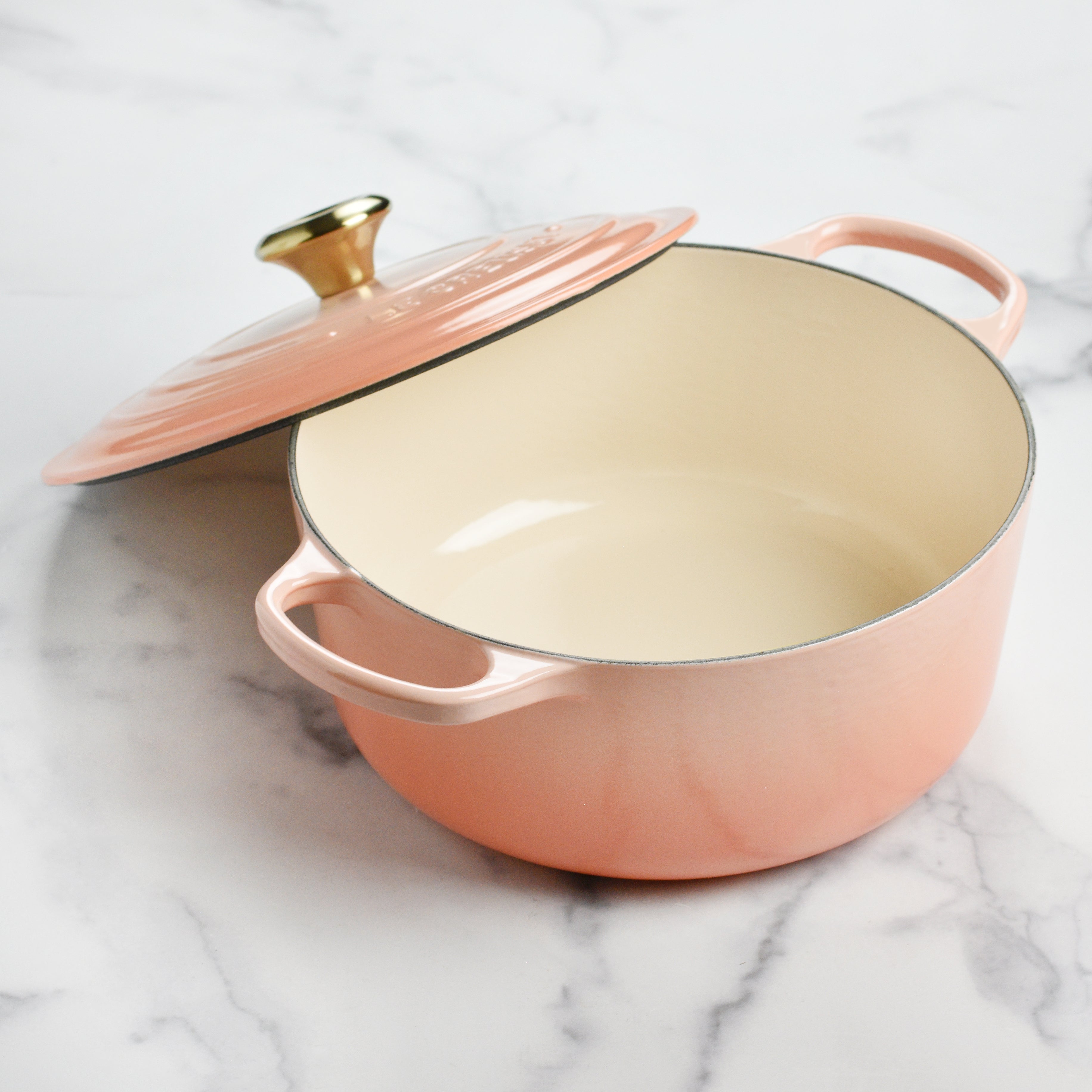 Close-up of ergonomic handles and stainless steel knob on Le Creuset Dutch oven for easy lifting