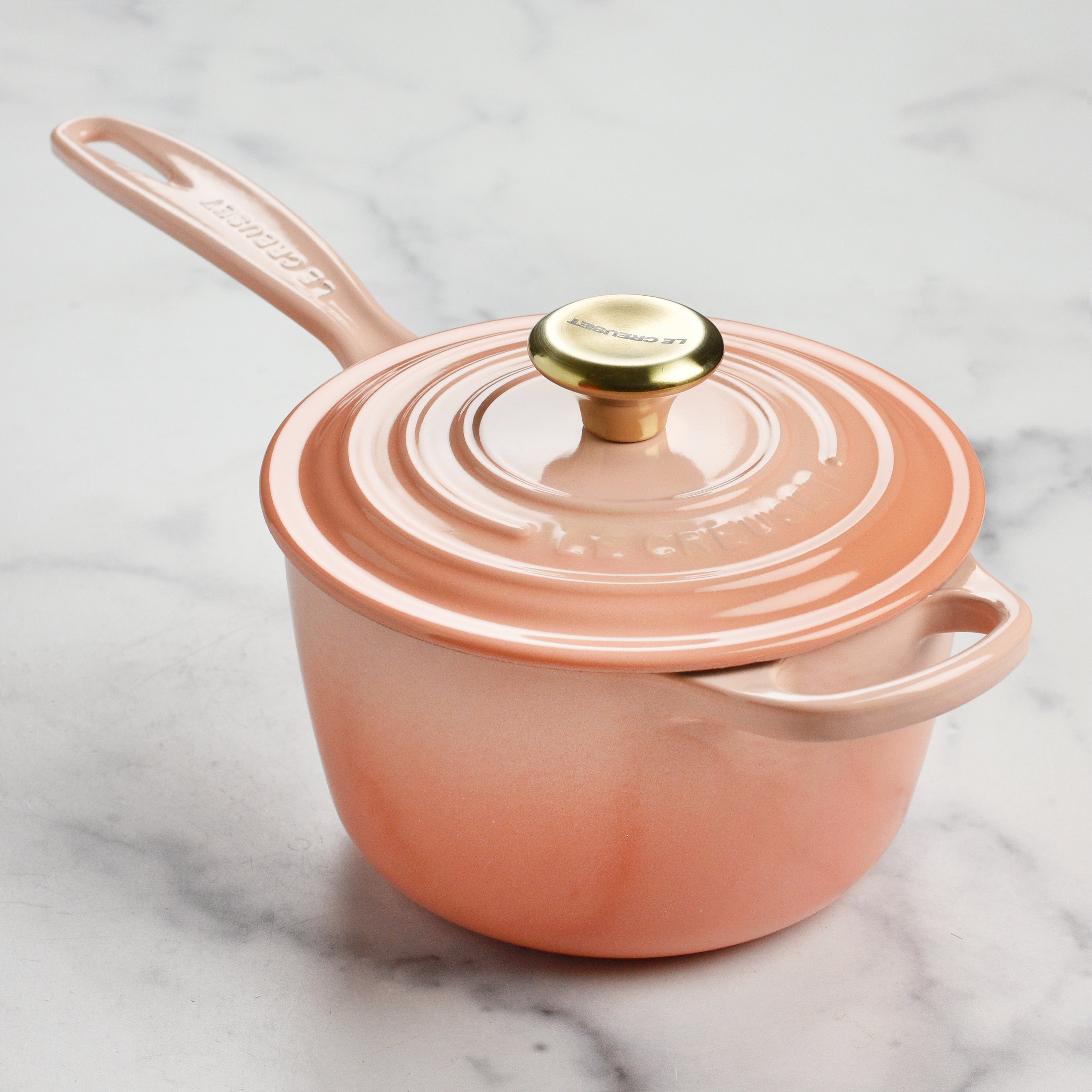 Side view of Le Creuset 1.75 qt saucepan with ergonomic handle and tight-fitting lid.